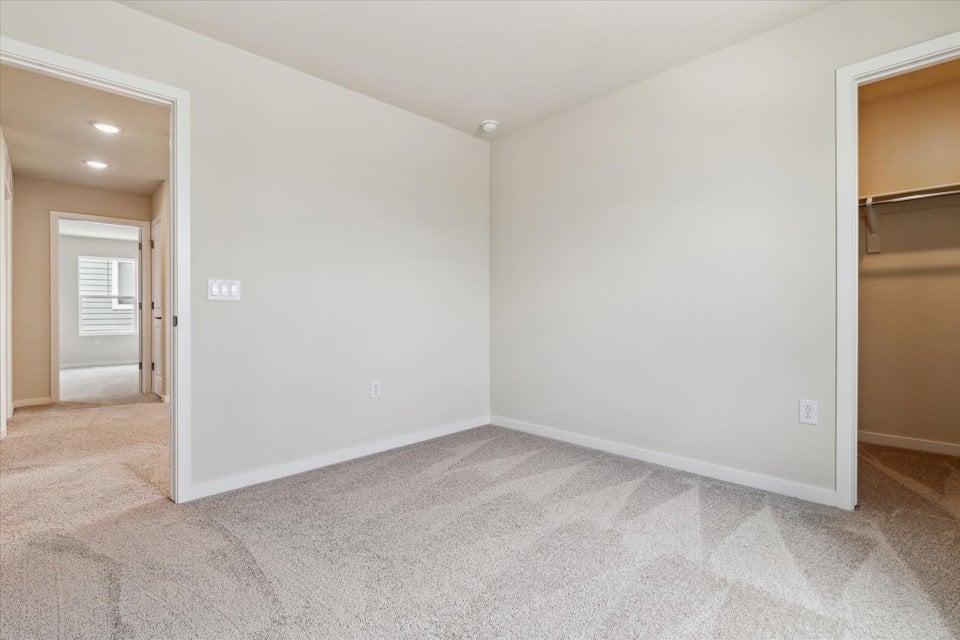 A room with a carpet and a door.