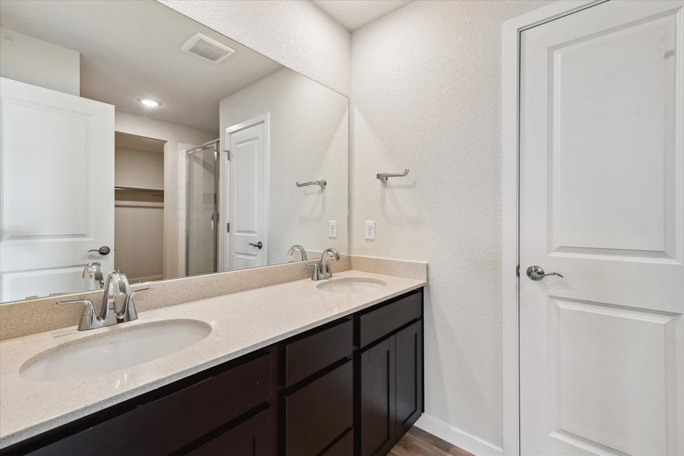 A bathroom with a large mirror.