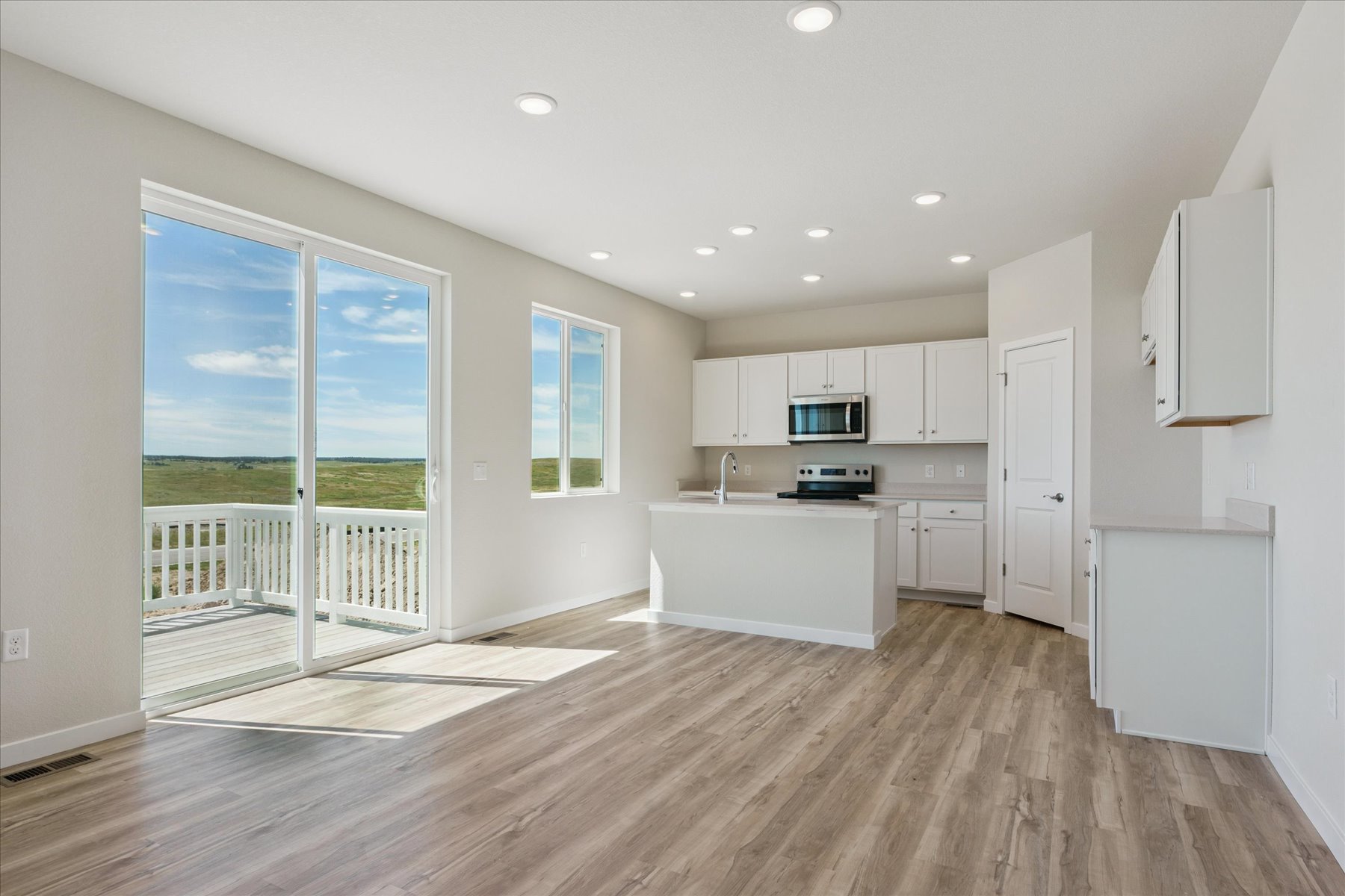 A kitchen with white cabinets.