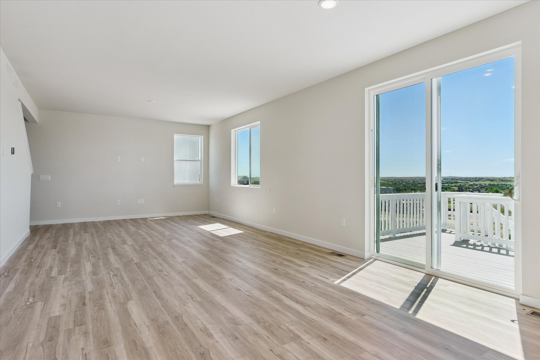 A room with a wood floor and a wood floor with a glass door.