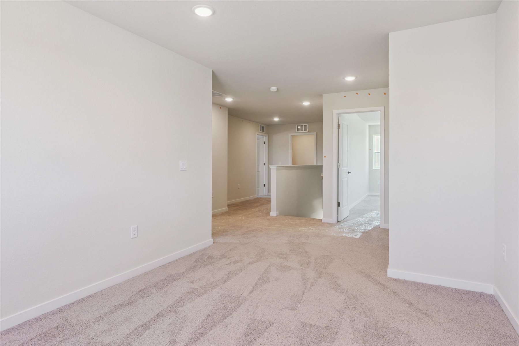A long hallway with white walls.