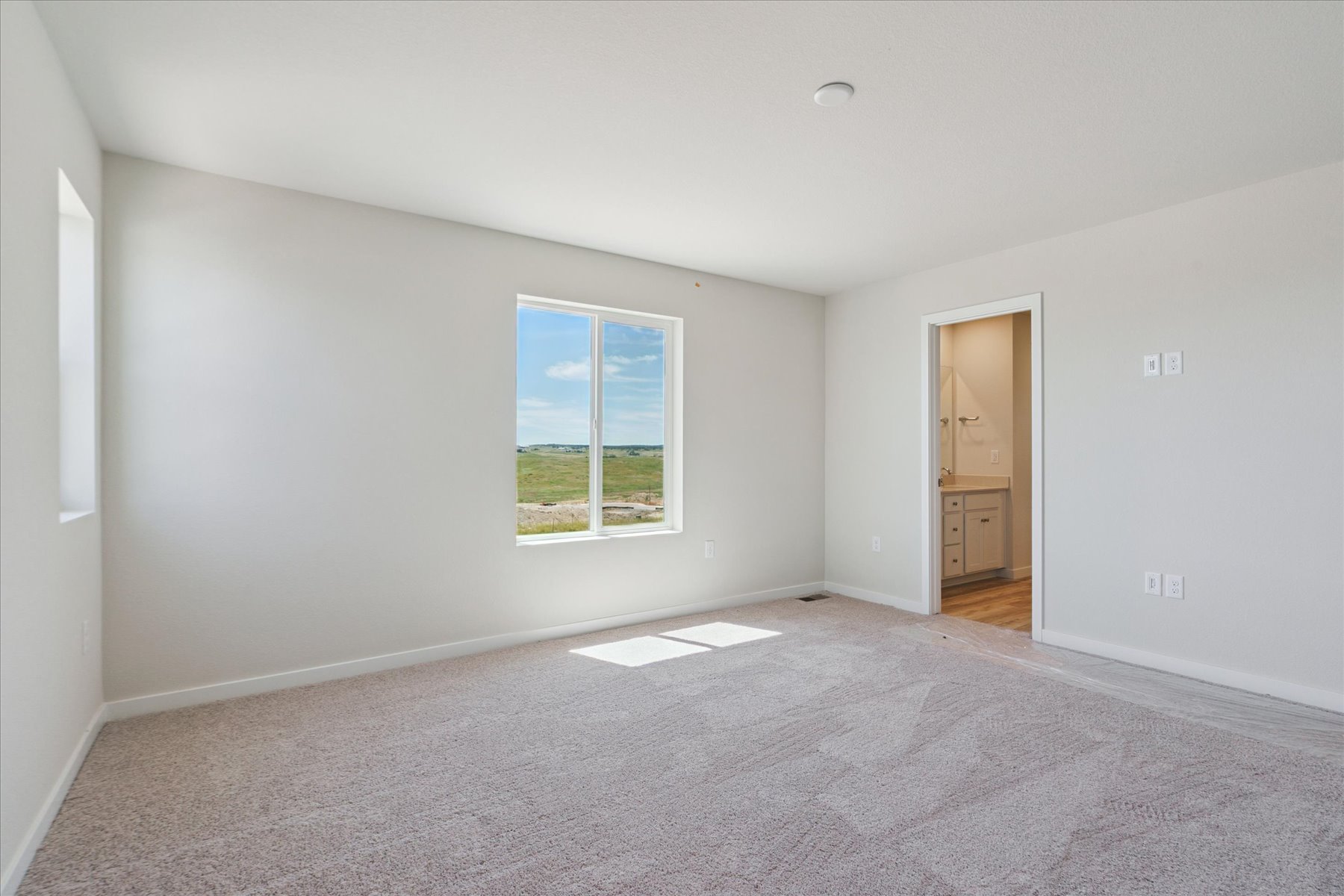 A room with a window and a door.