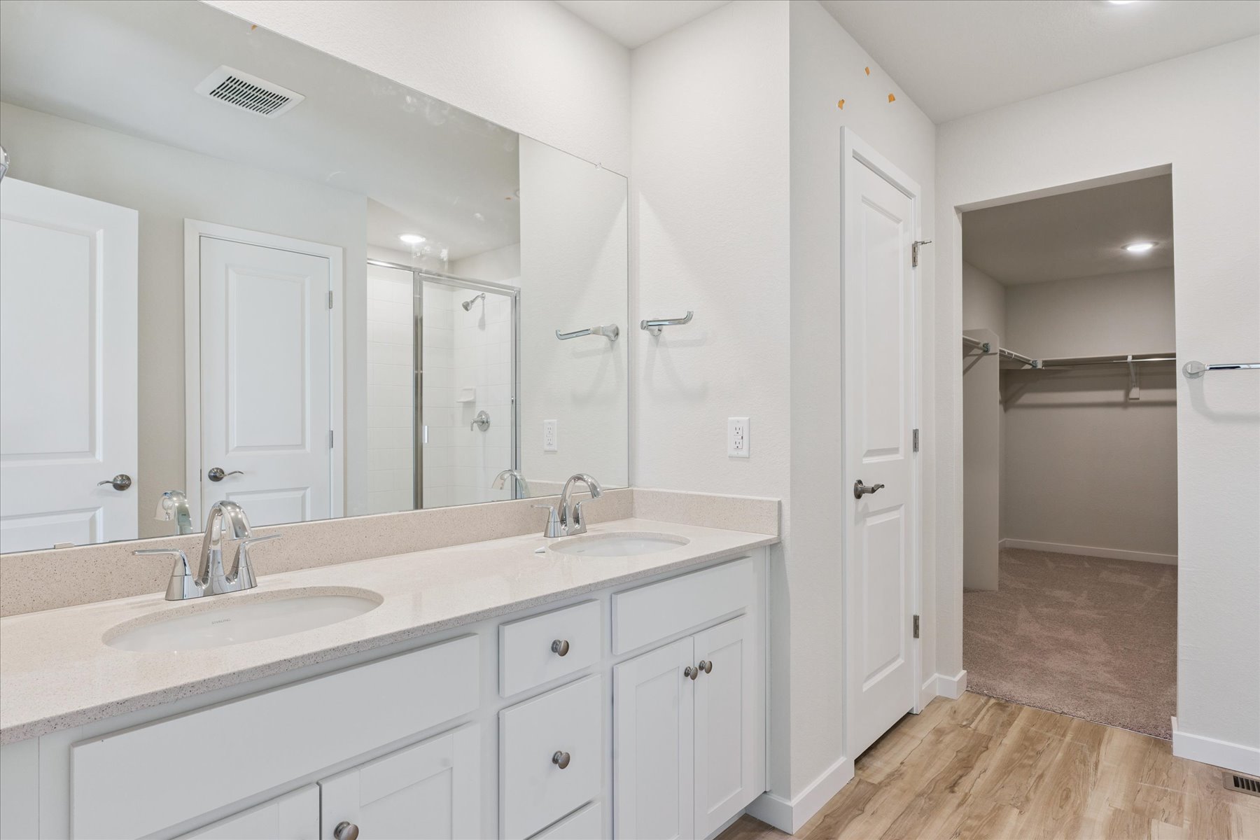 A bathroom with white cabinets.