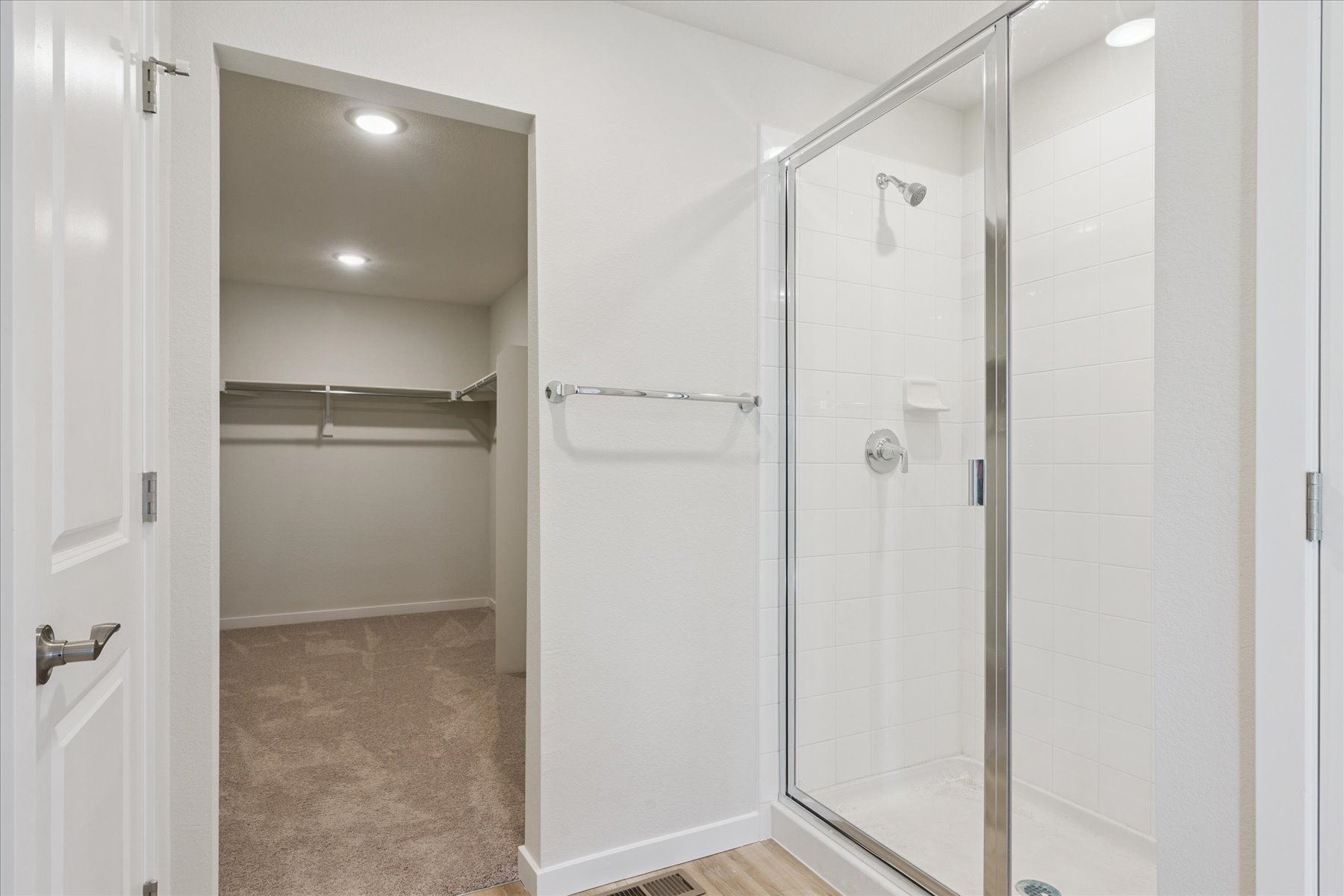 A shower with a glass door.