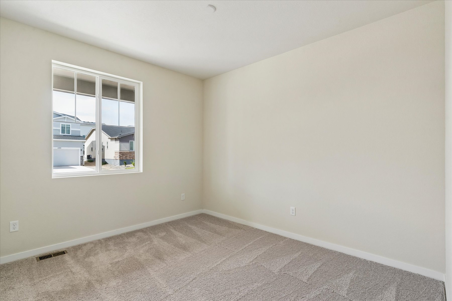 A room with a window and carpet.