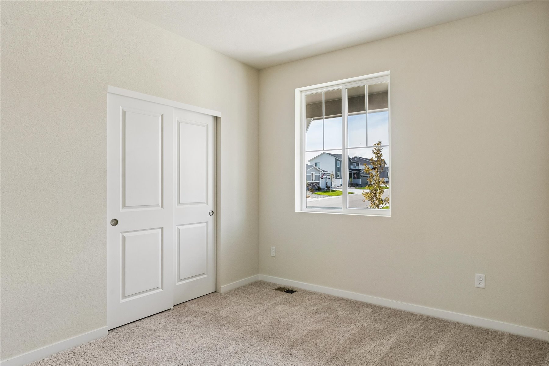 A room with a window and a door with a window.
