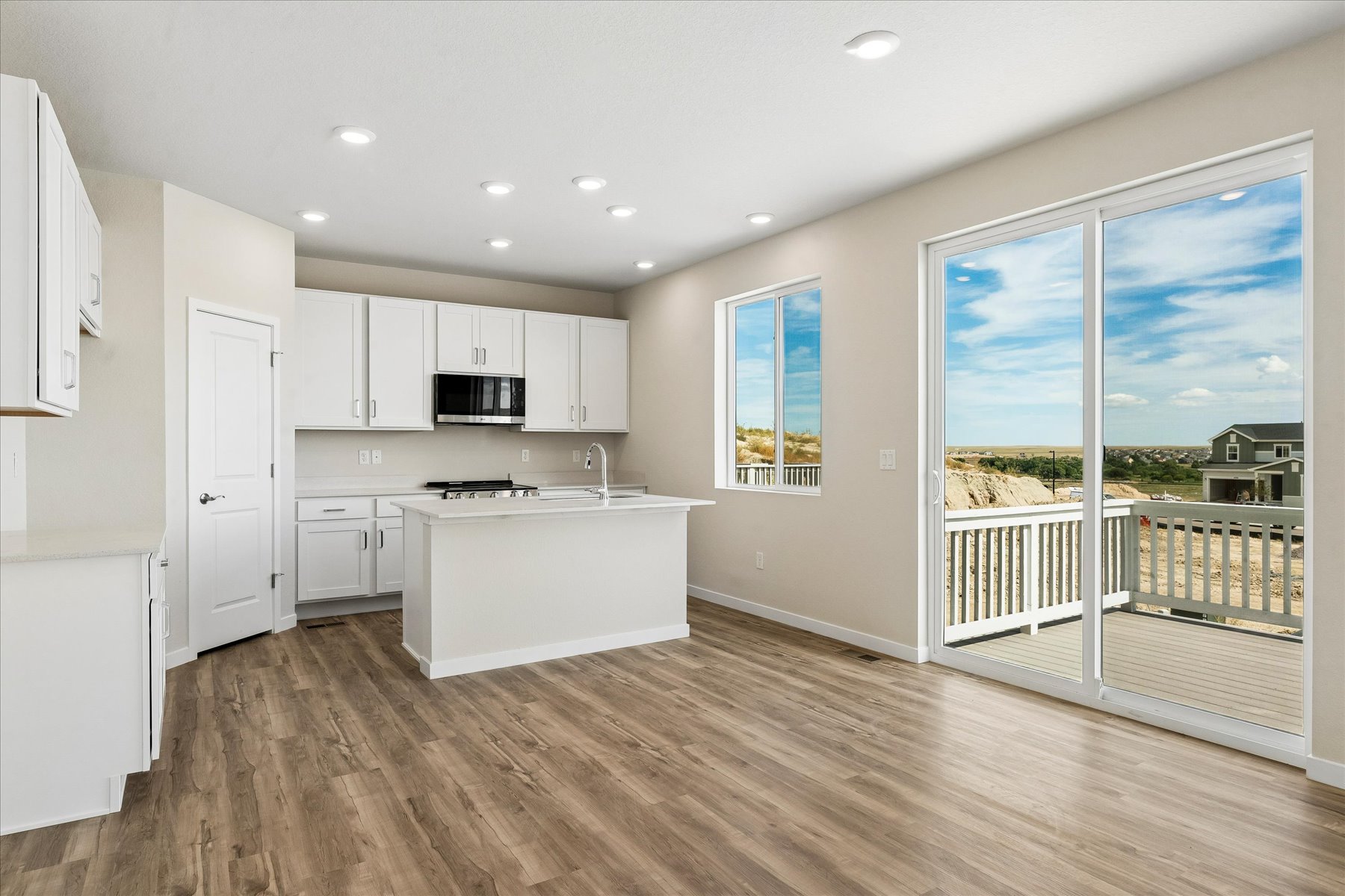 A kitchen with white cabinets.