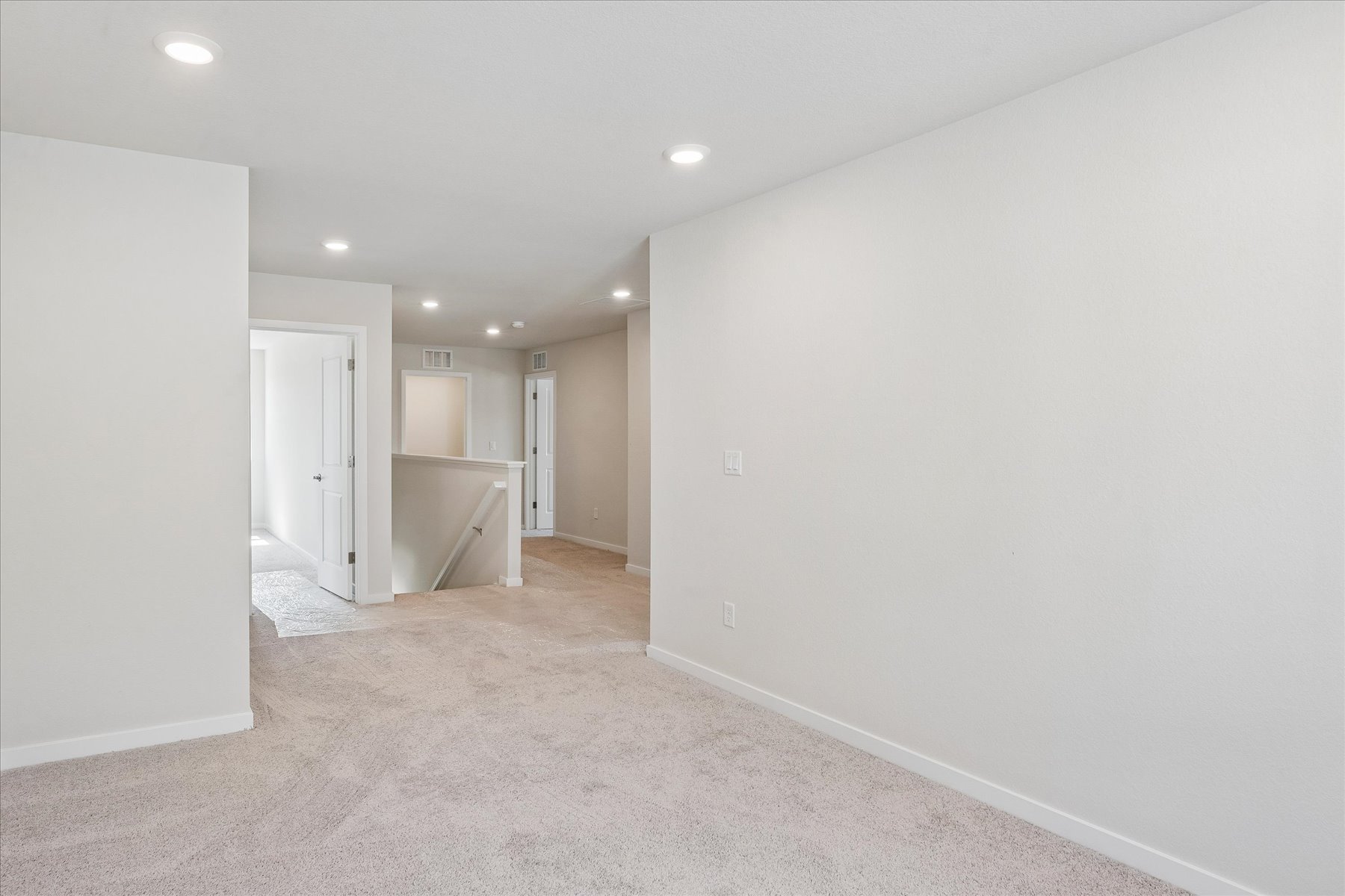 A long hallway with white walls.
