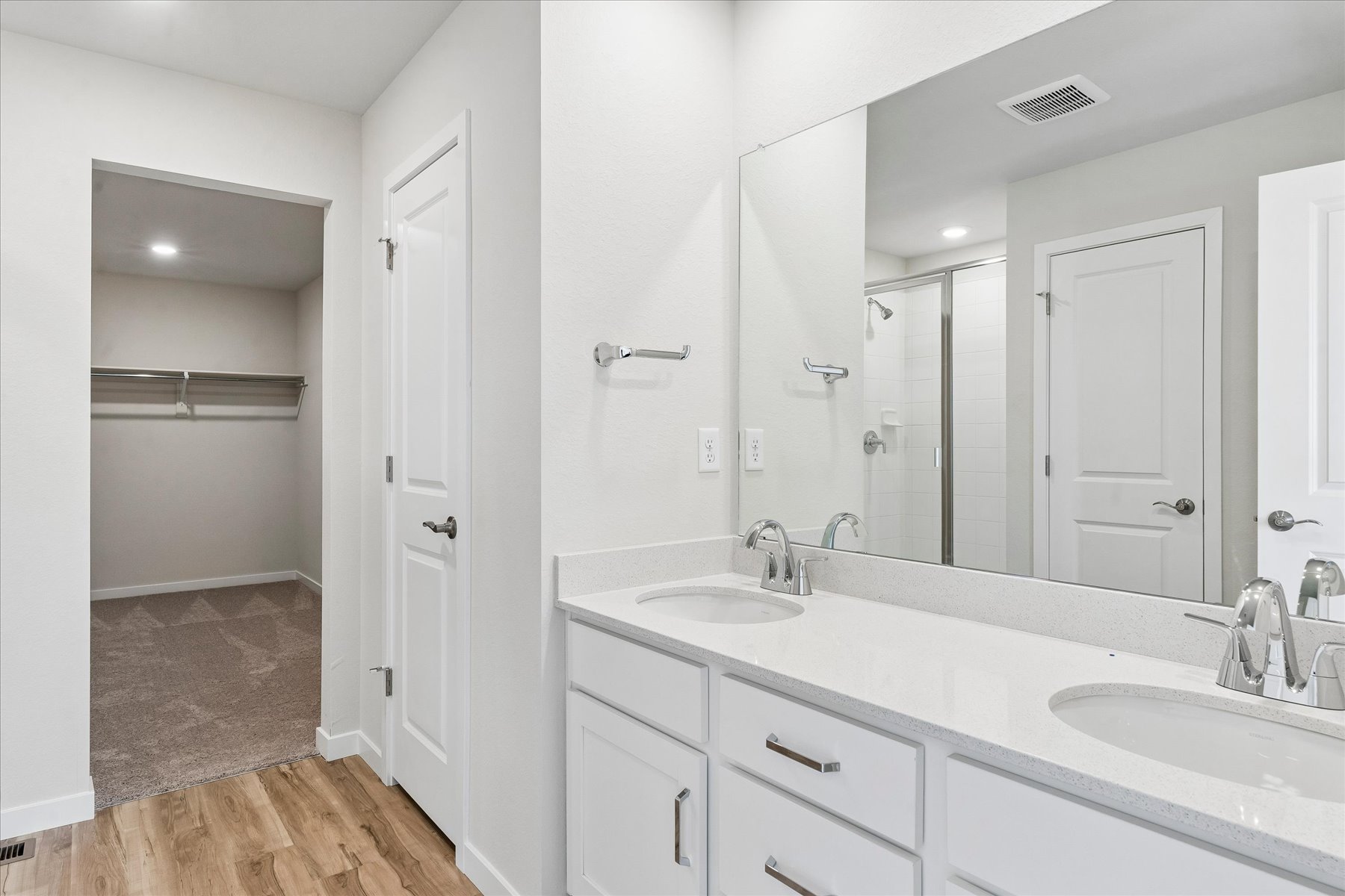 A bathroom with a large mirror.