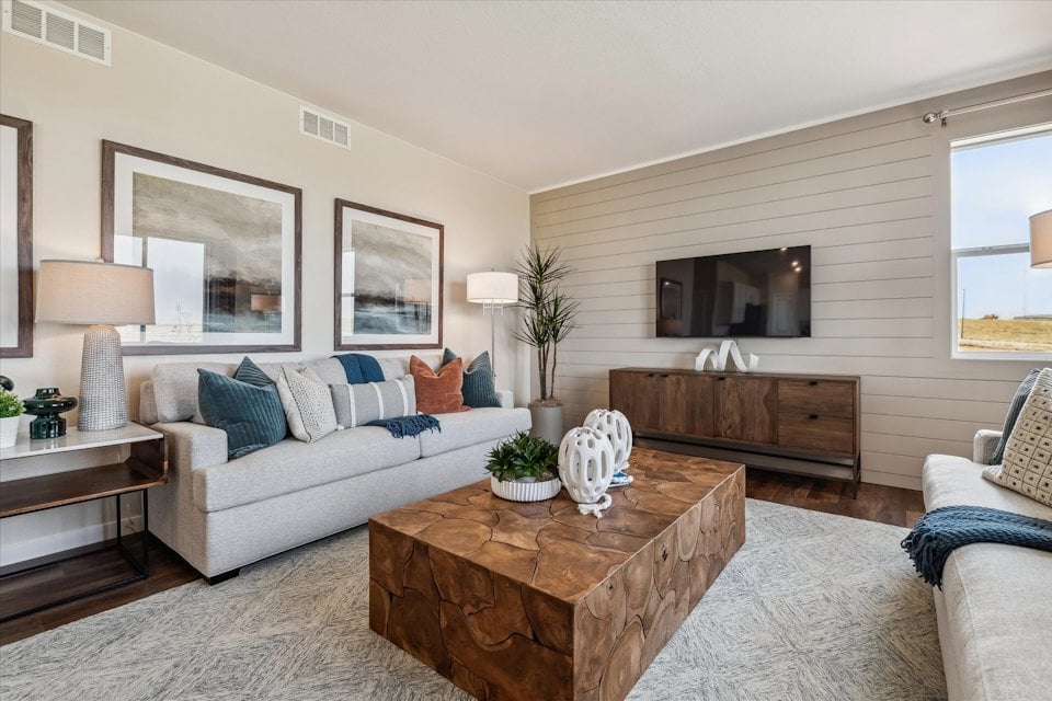 A living room with a couch and a table.