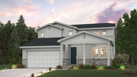 A house with a garage and trees in the back.