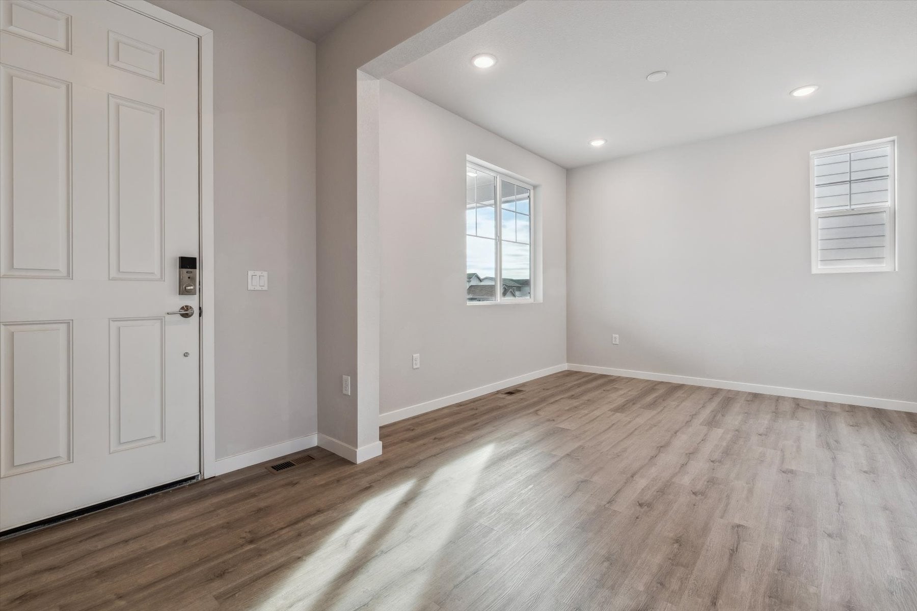 A room with white walls and a wood floor.