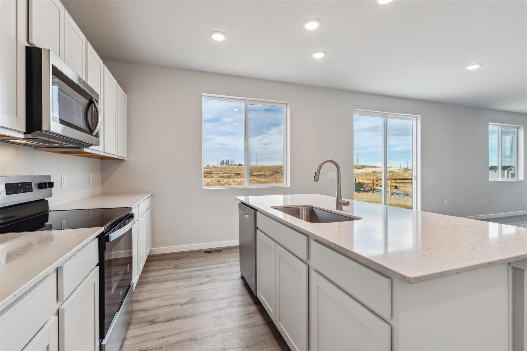 A kitchen with white cabinets.