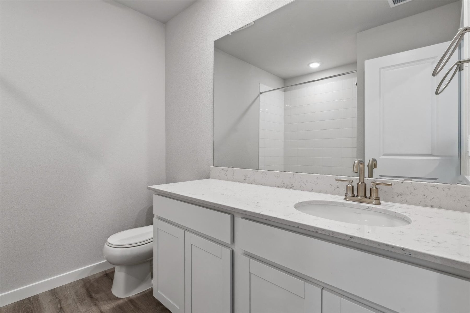 A bathroom with a large mirror.