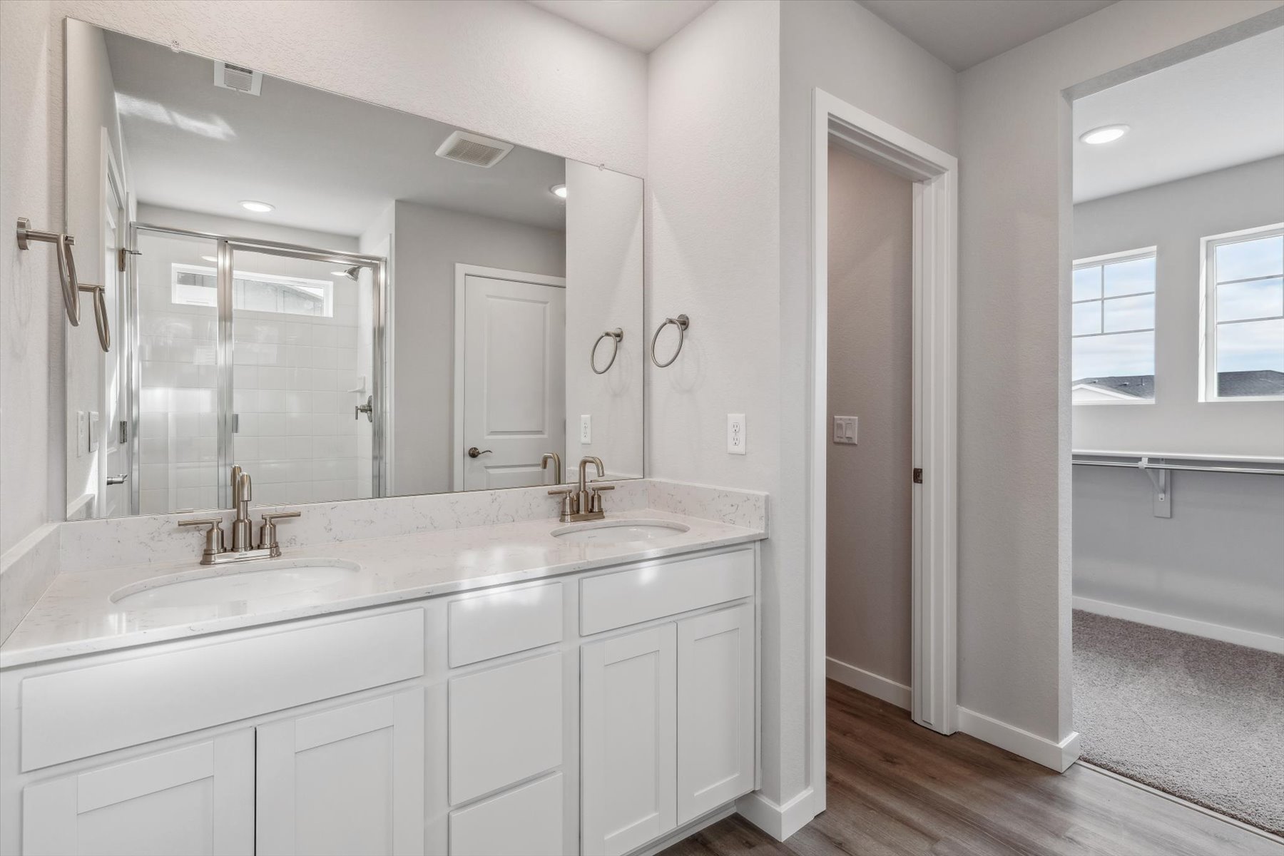 A bathroom with white cabinets.