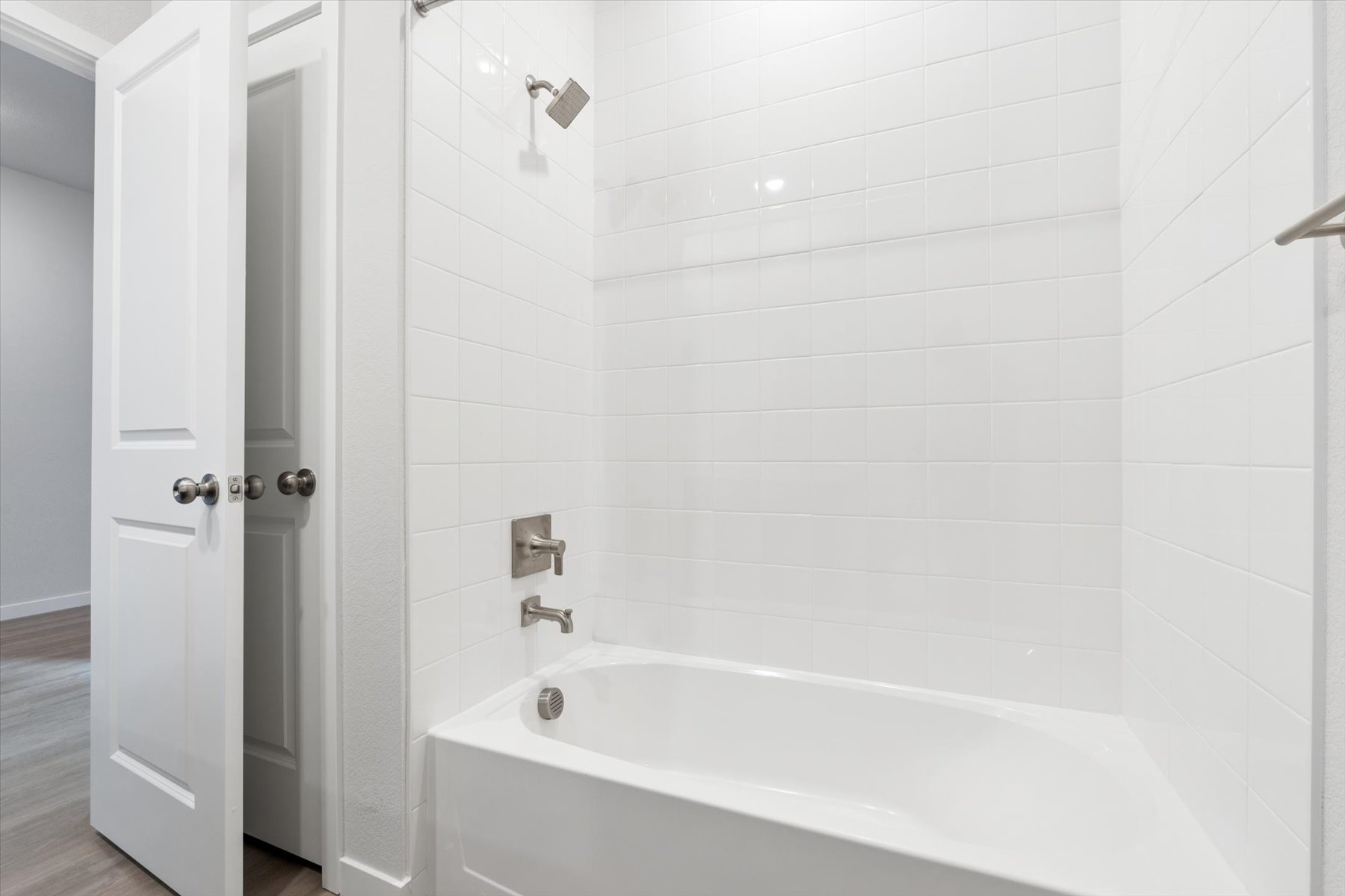 A bathroom with a bathtub and shower.