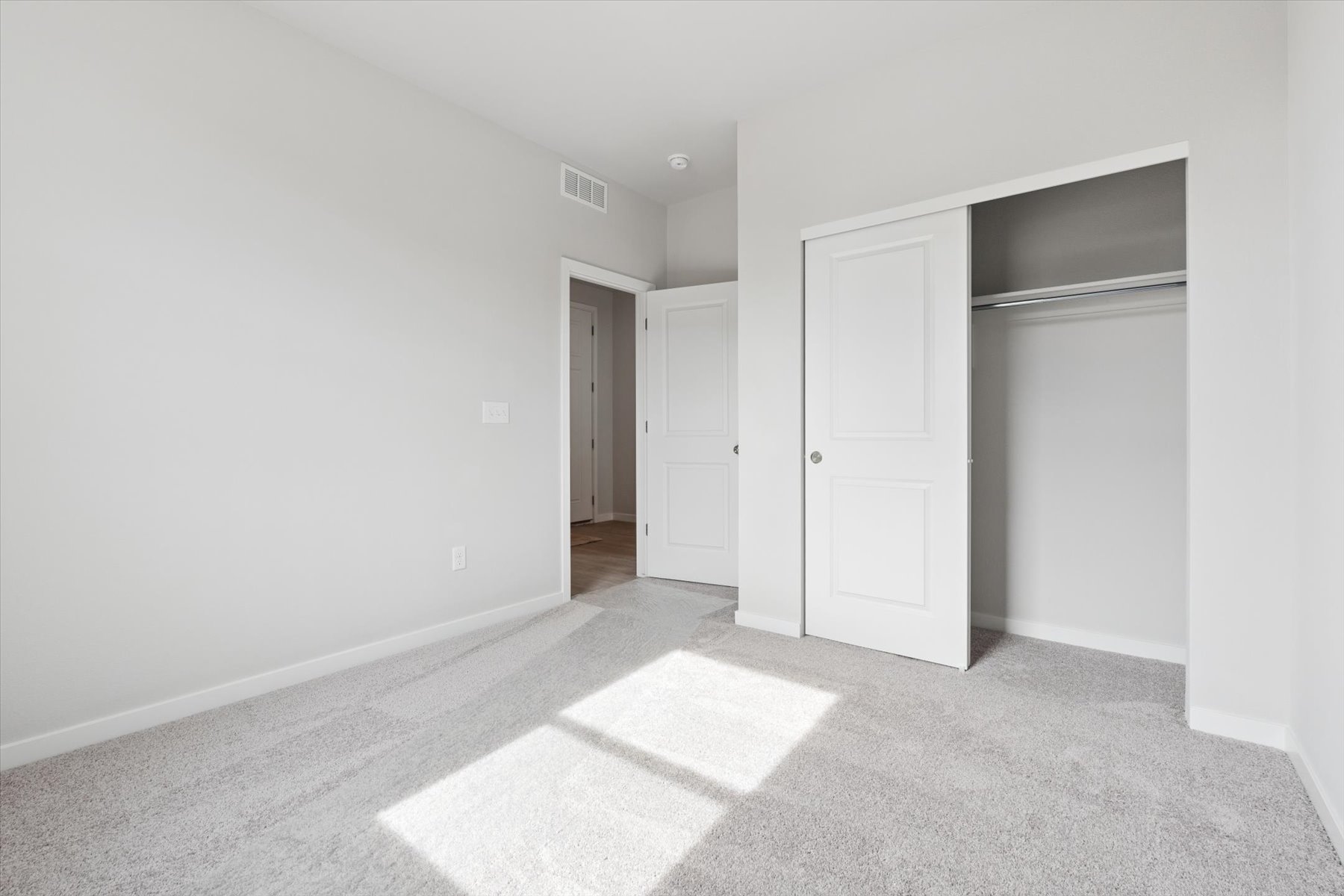 A hallway with white doors.