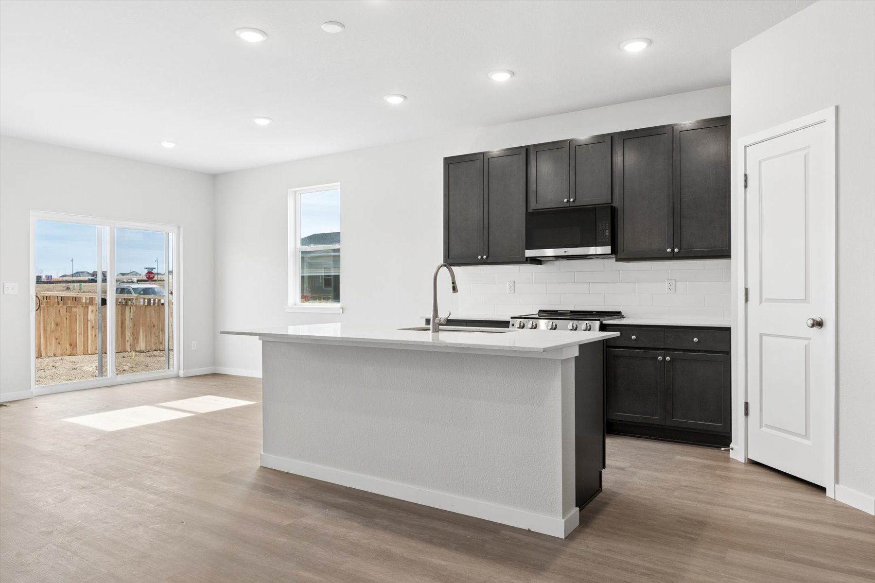 A kitchen with black cabinets.