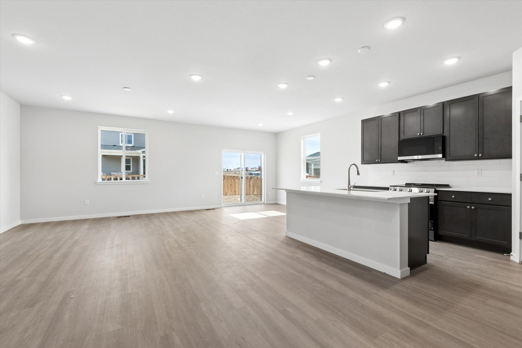 A kitchen with black cabinets.