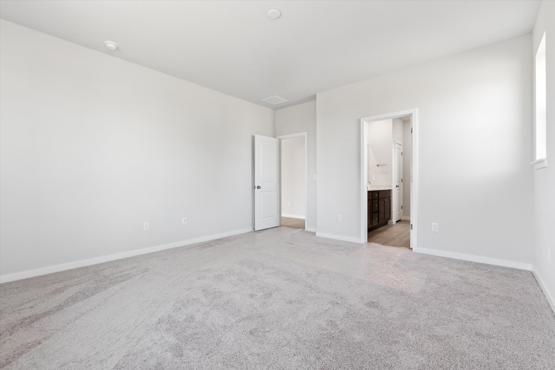 A long hallway with white walls.