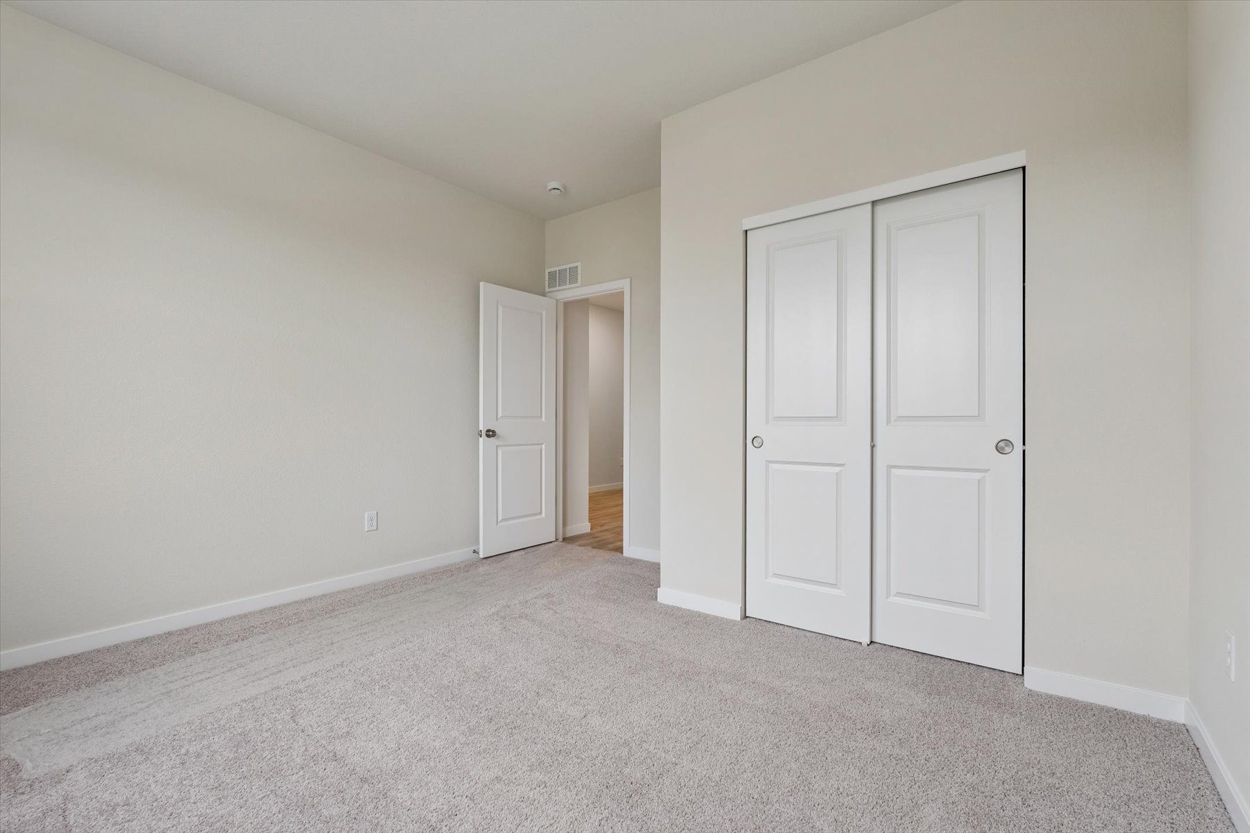 A hallway with white doors.