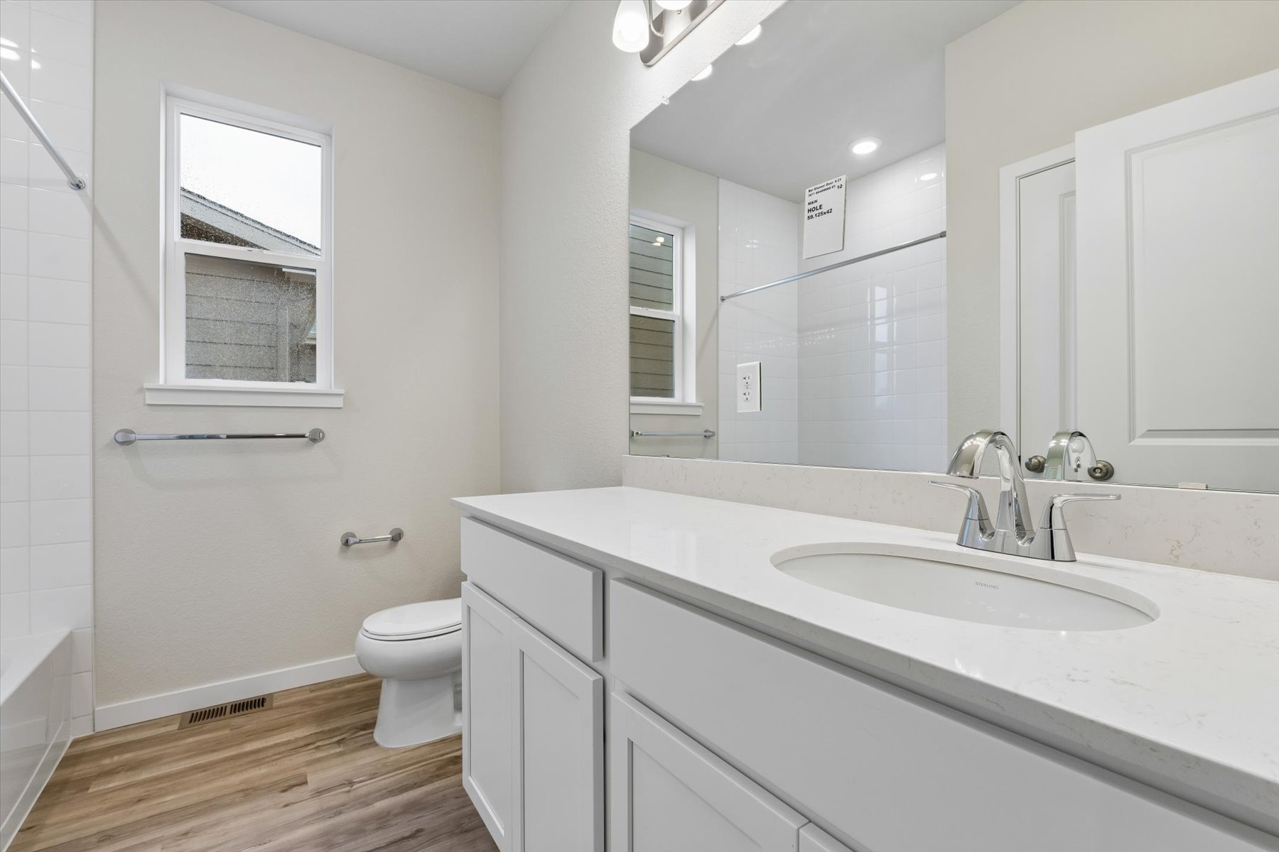 A bathroom with a large mirror.