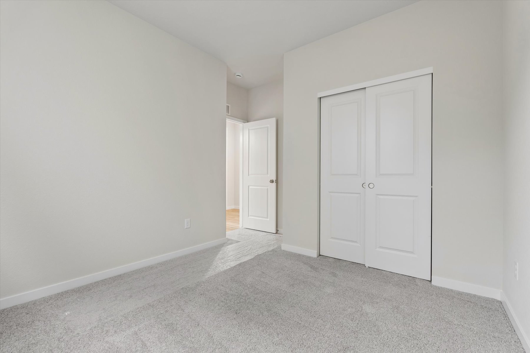 A hallway with white doors.