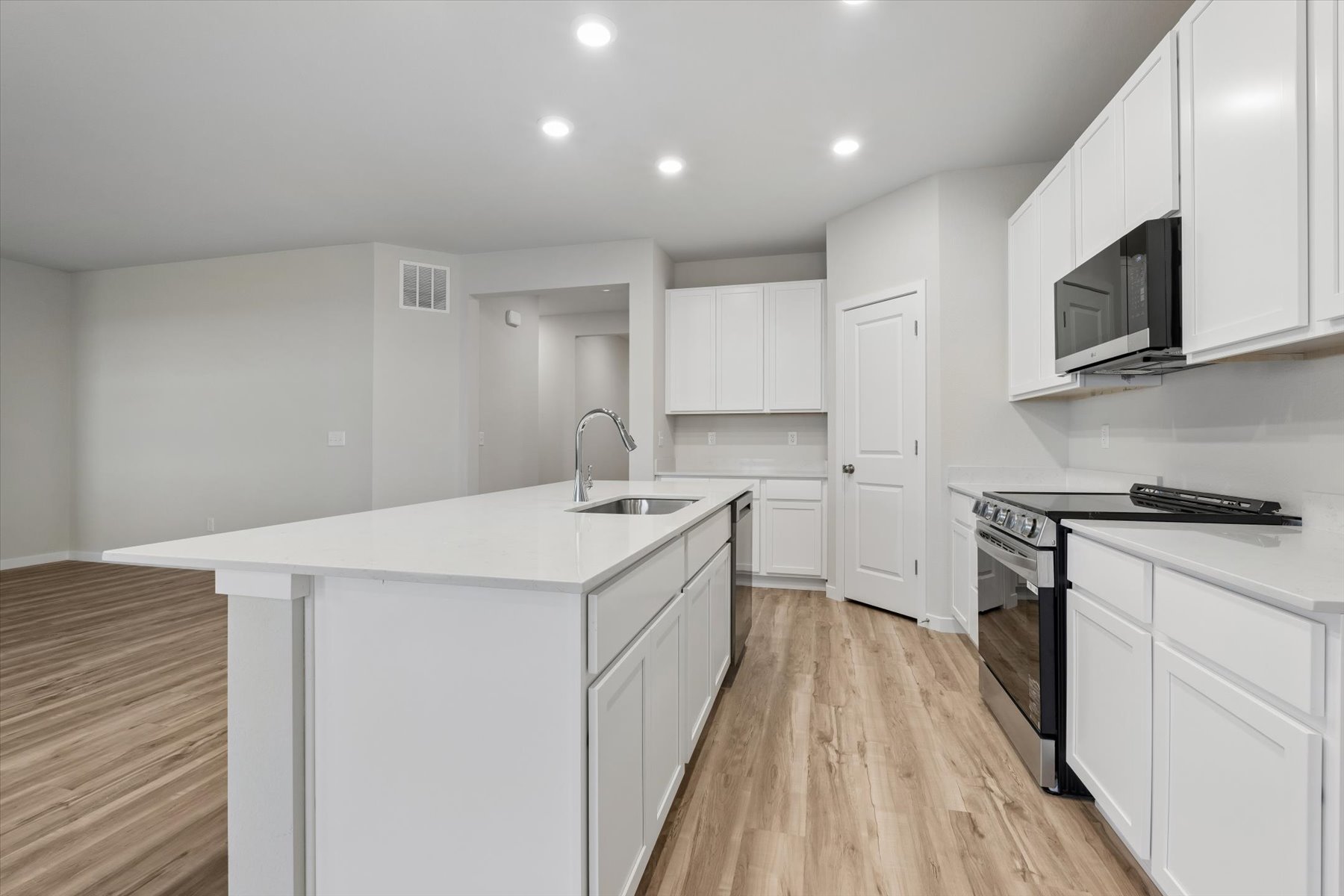 A kitchen with white cabinets.