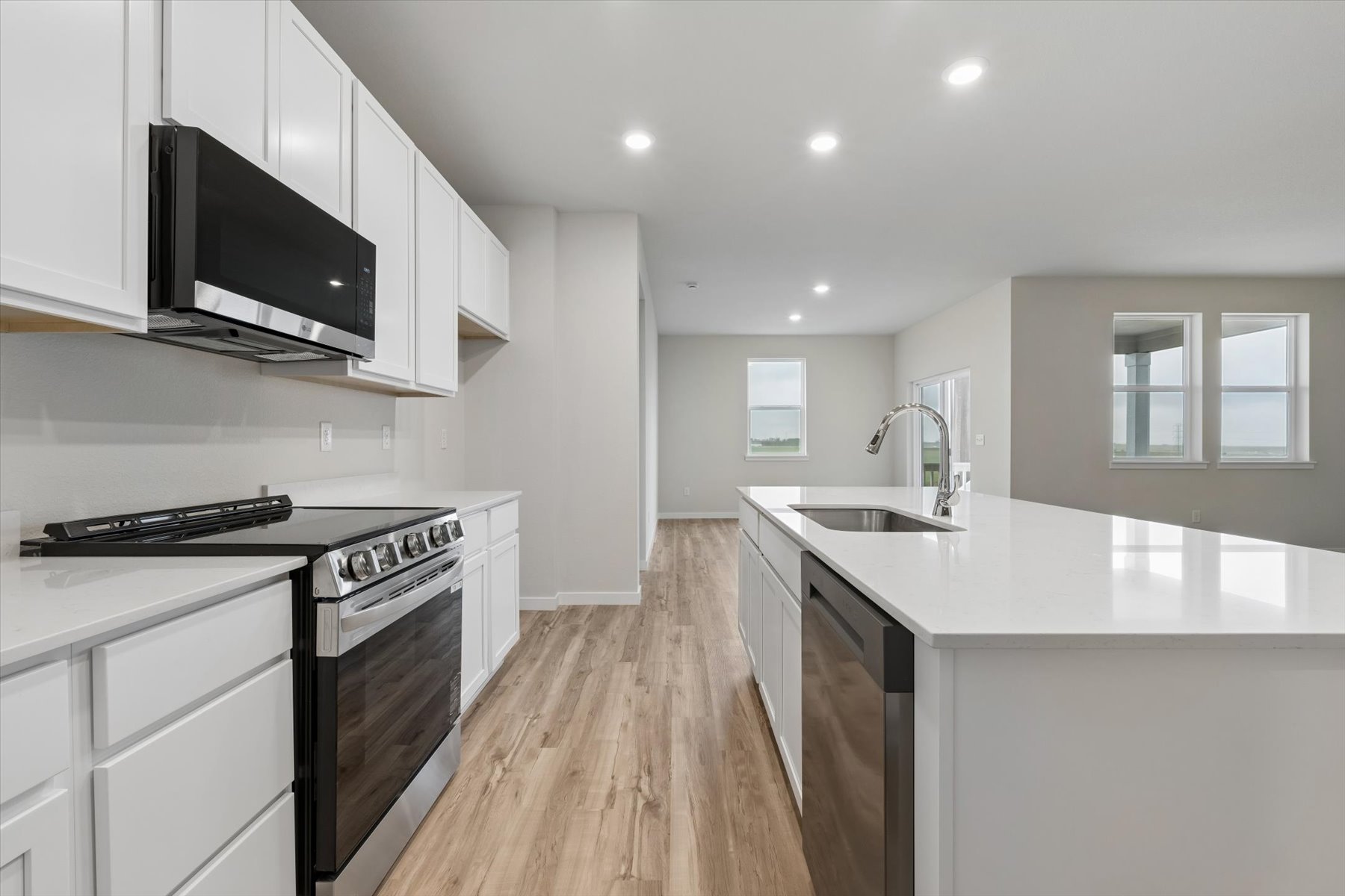 A kitchen with white cabinets.
