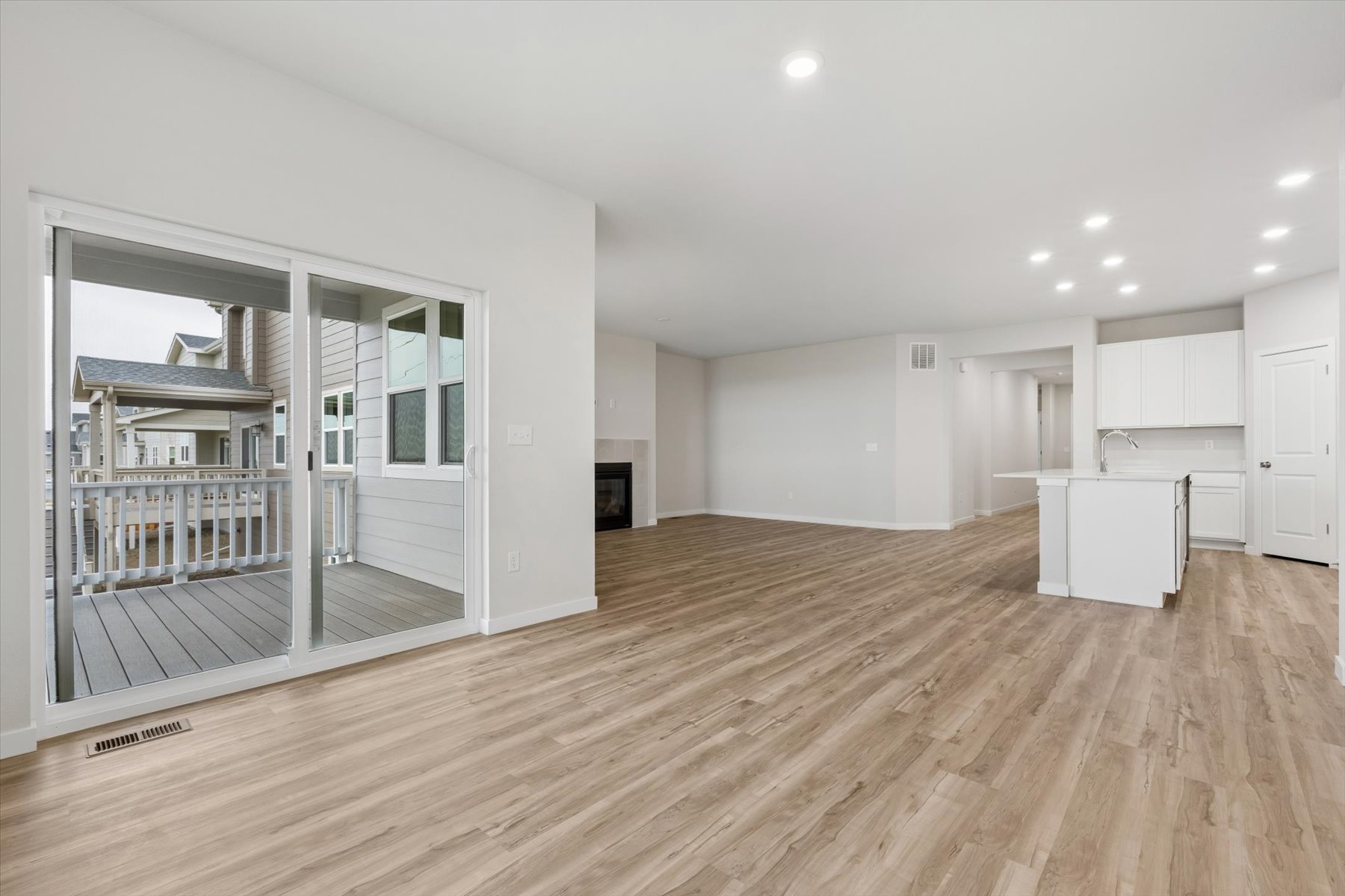 A large empty room with a wood floor and white walls.