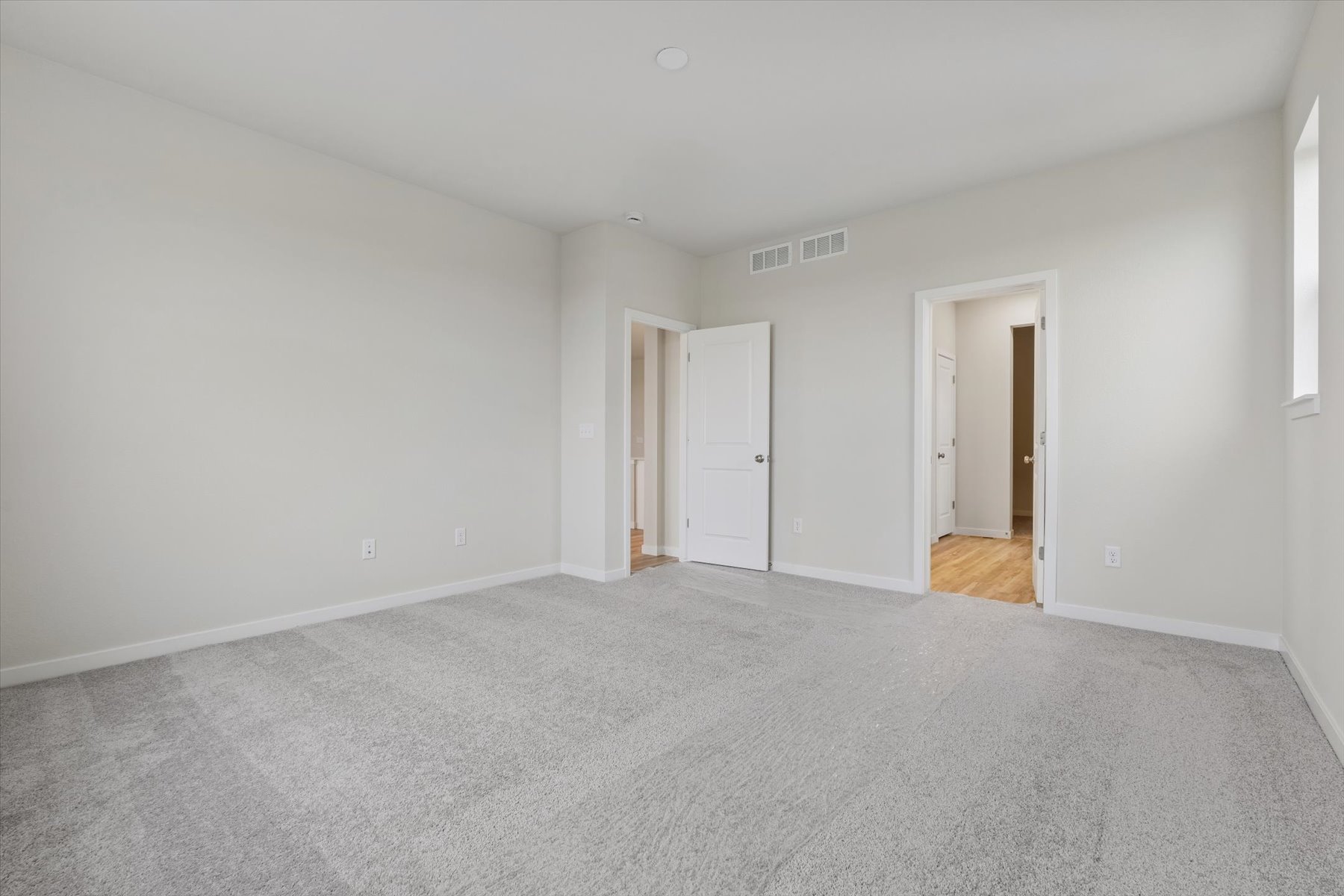 A hallway with white walls.