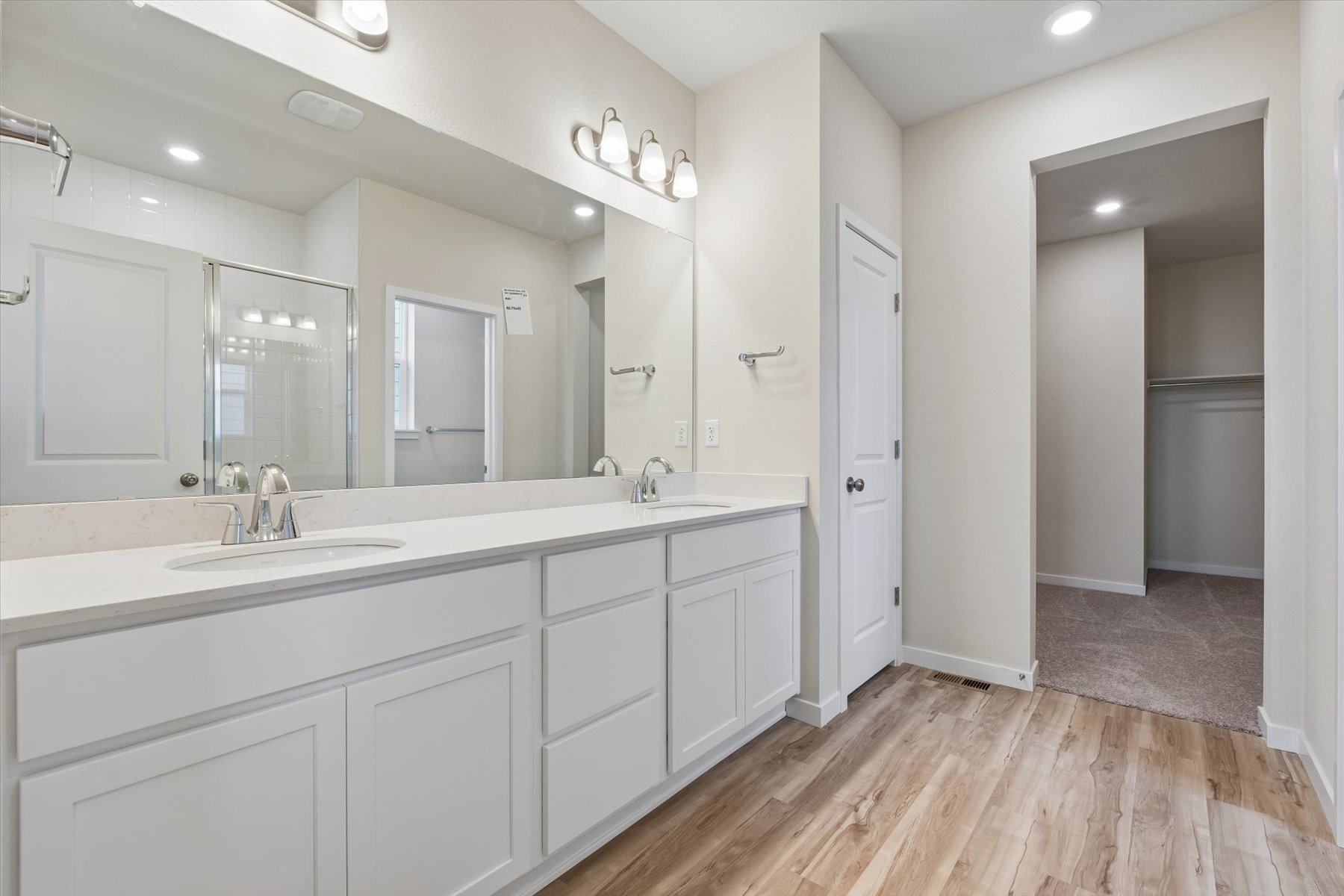 A bathroom with white cabinets.