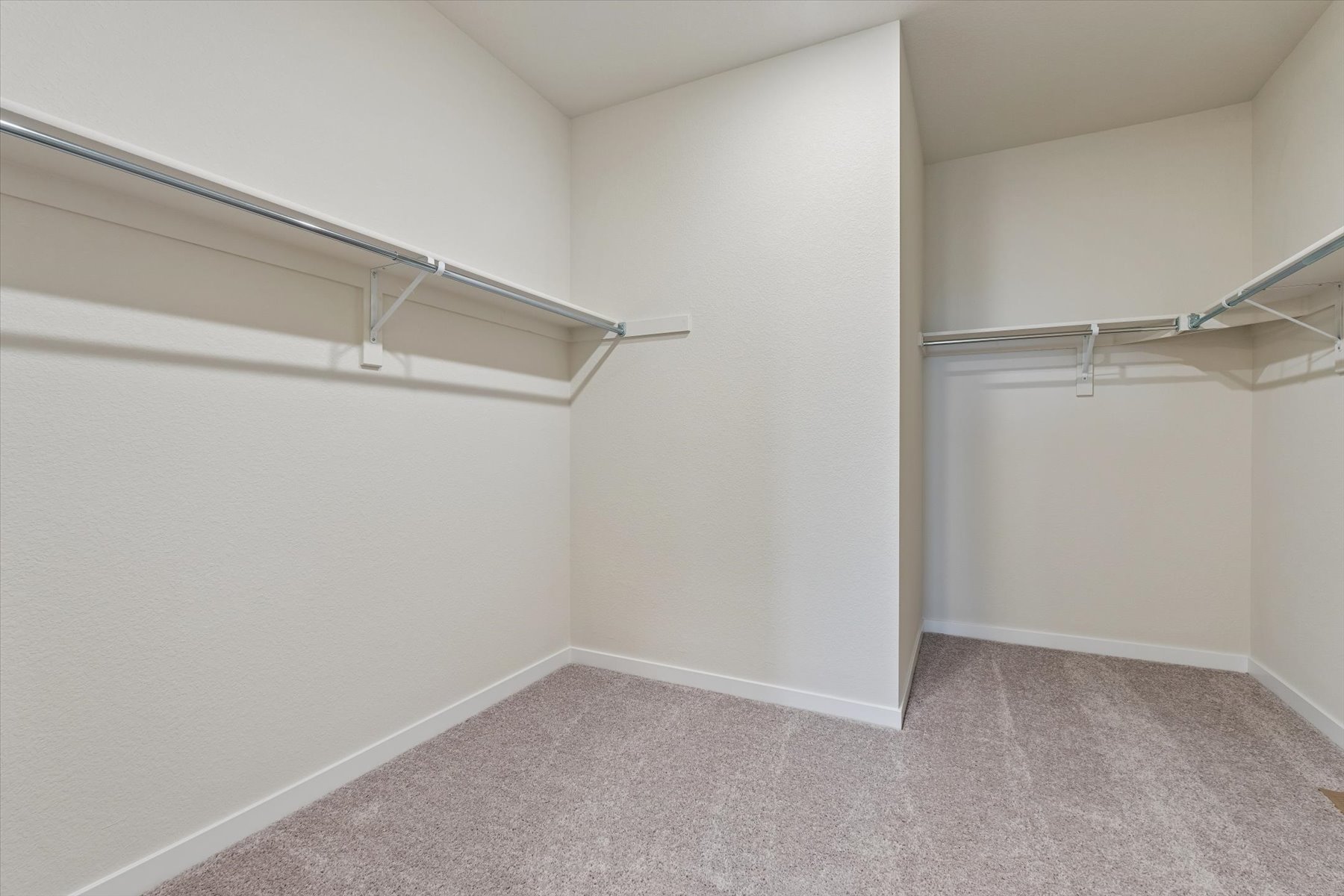A white room with a metal railing.