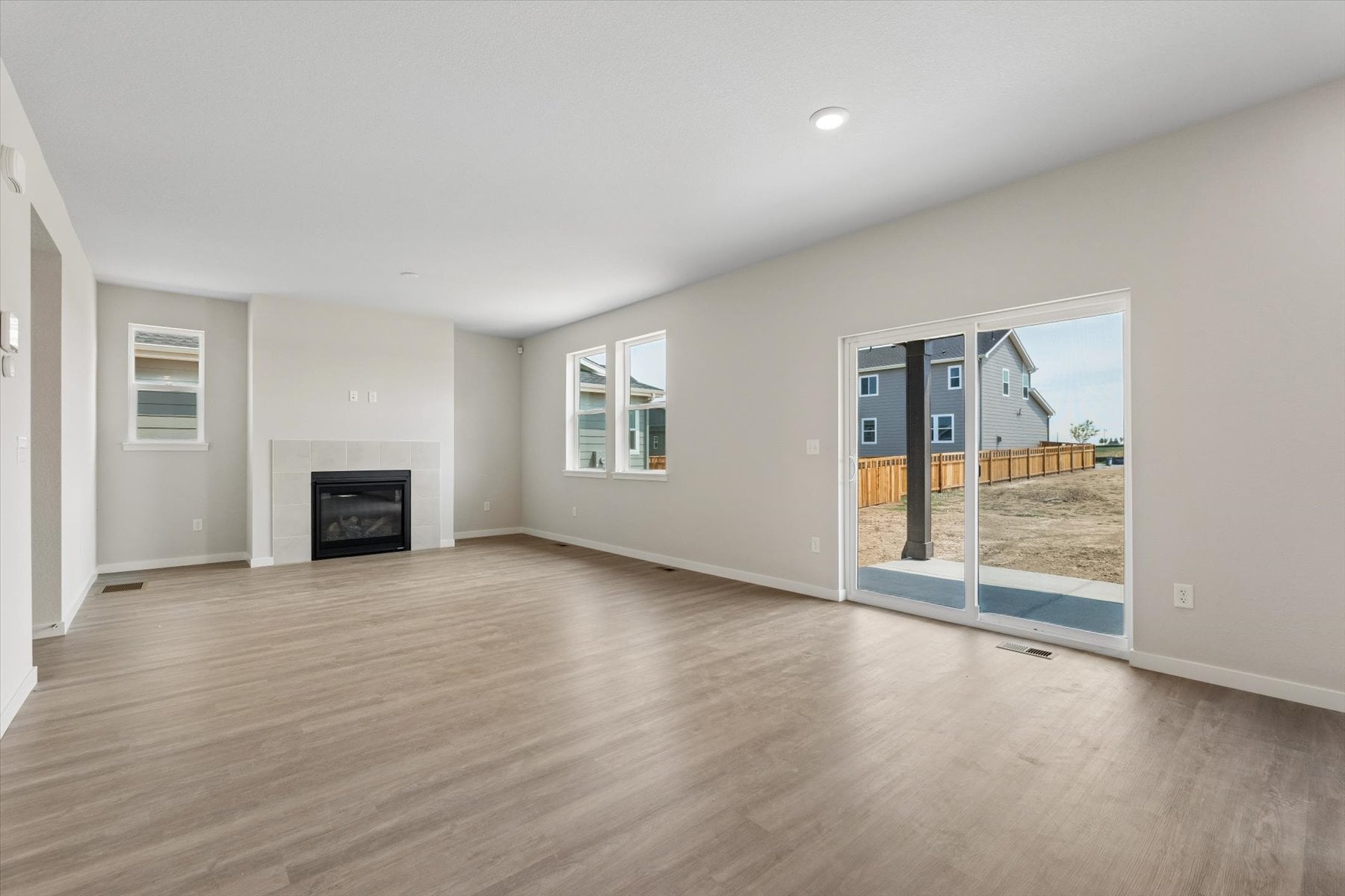 A room with a fireplace and a wood floor.