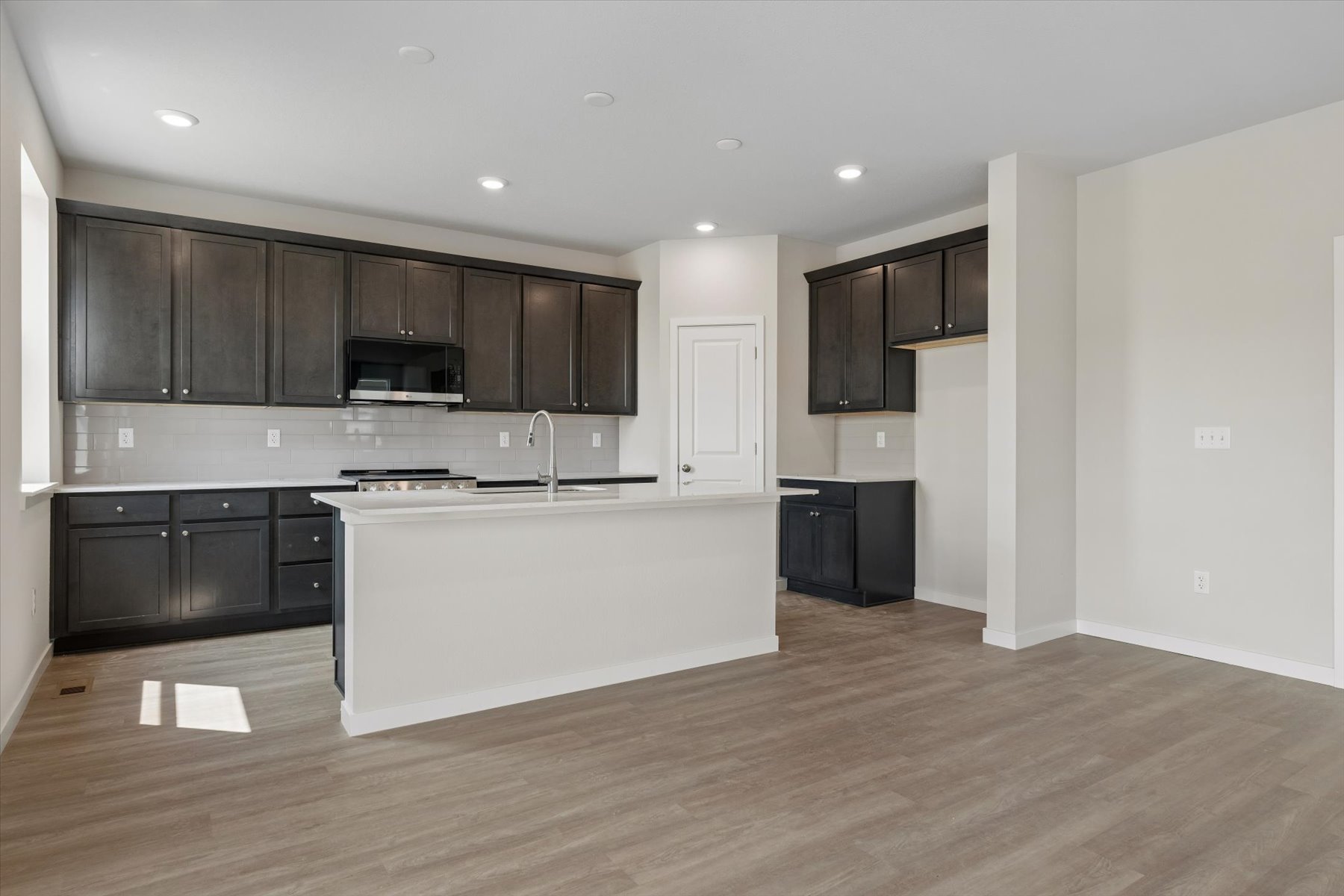 A kitchen with black cabinets.
