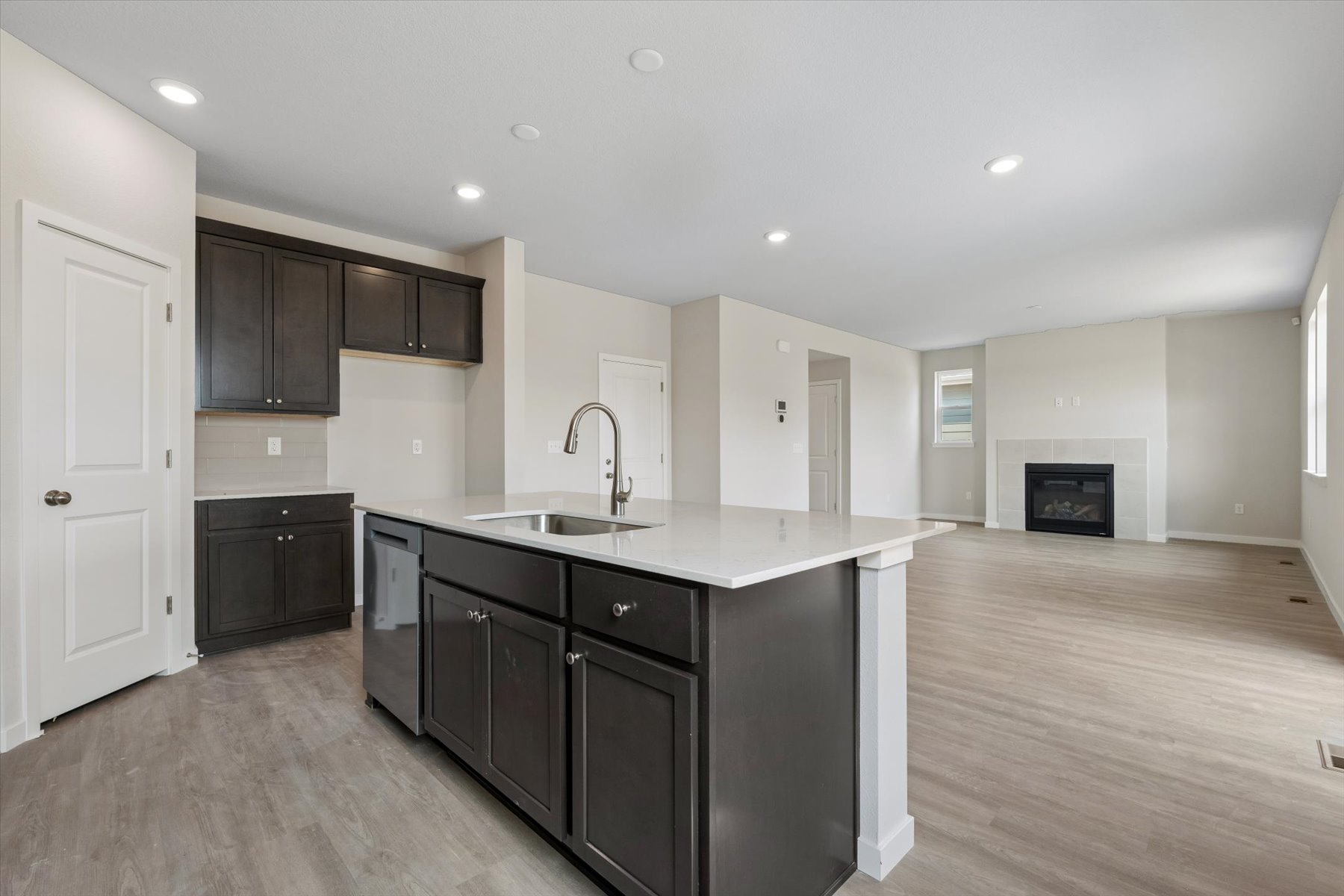 A kitchen with black cabinets.