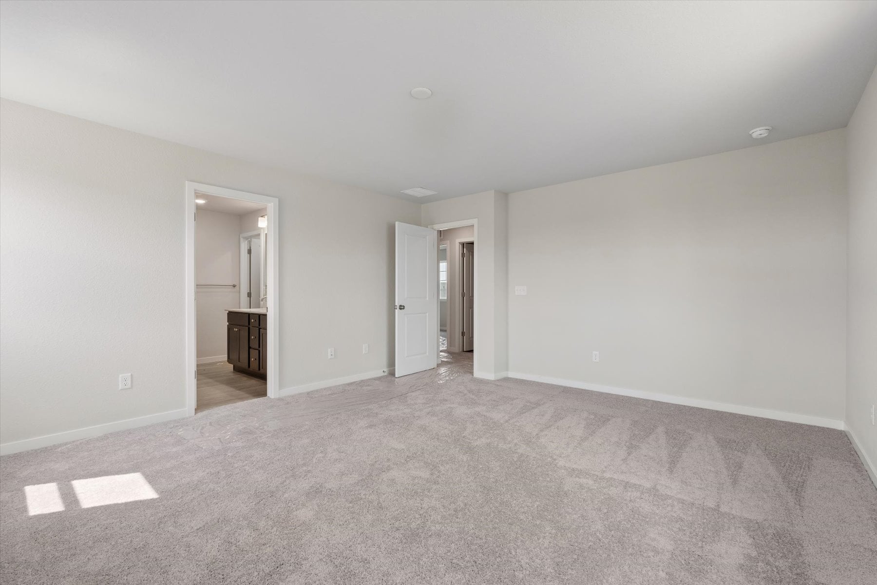 A long hallway with white walls.