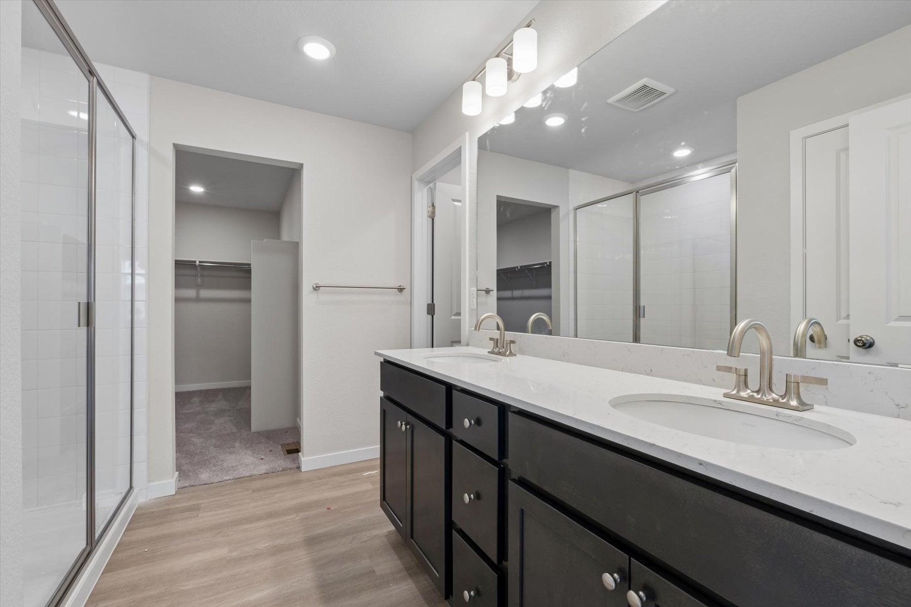A bathroom with a large mirror.