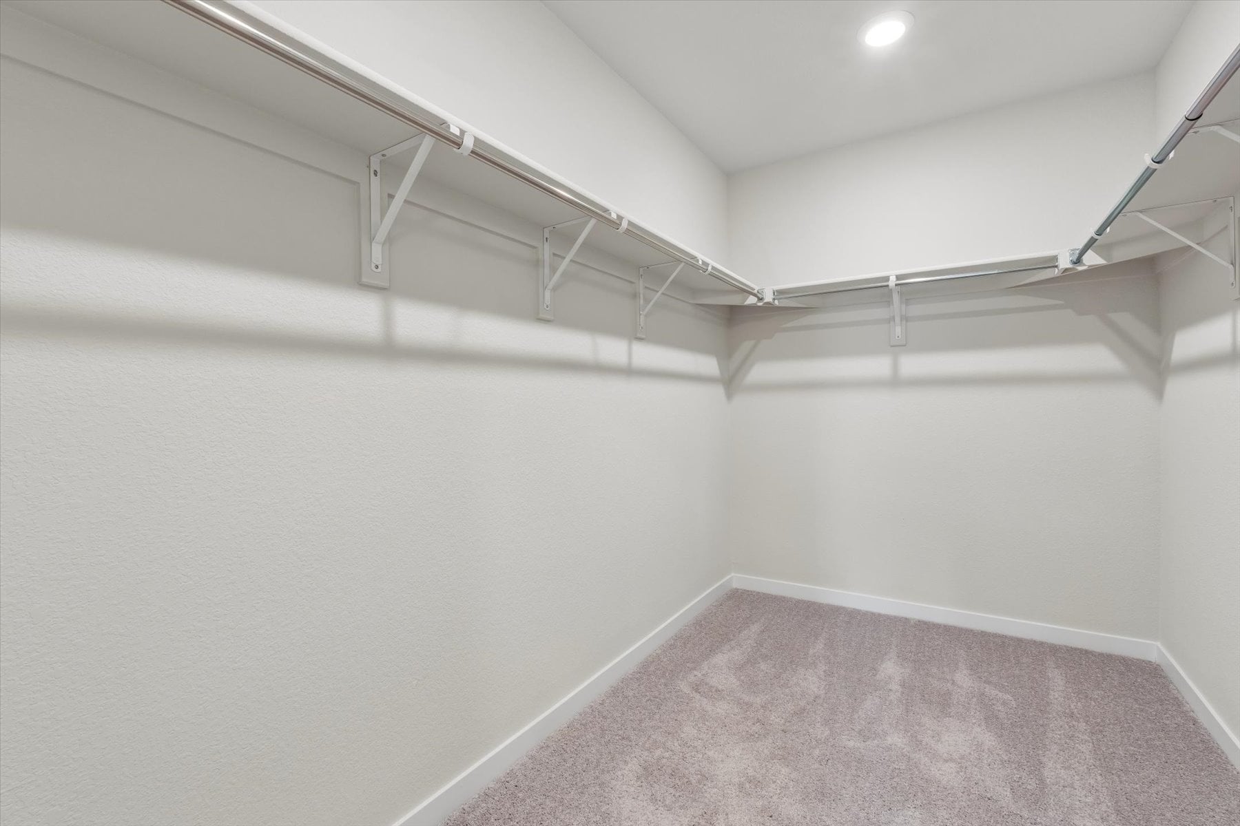 A white room with a carpet.