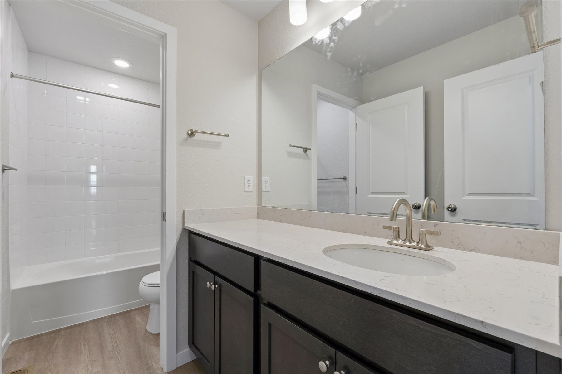 A bathroom with a sink and a tub.