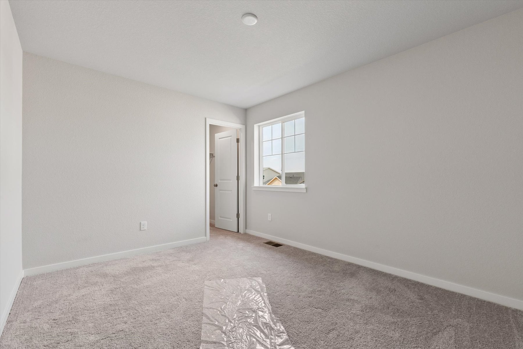 A room with a door and a rug in it.