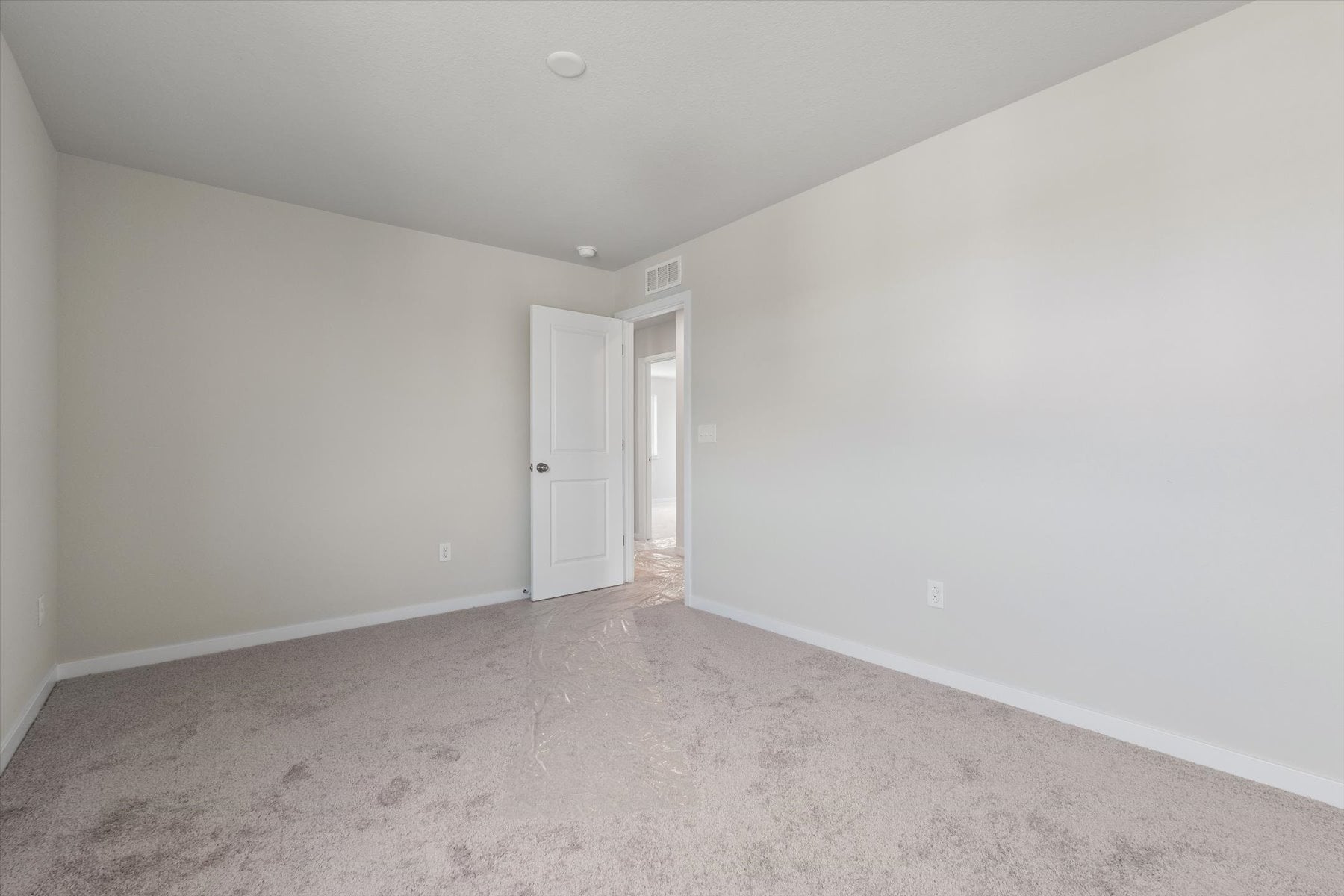 A hallway with white walls.