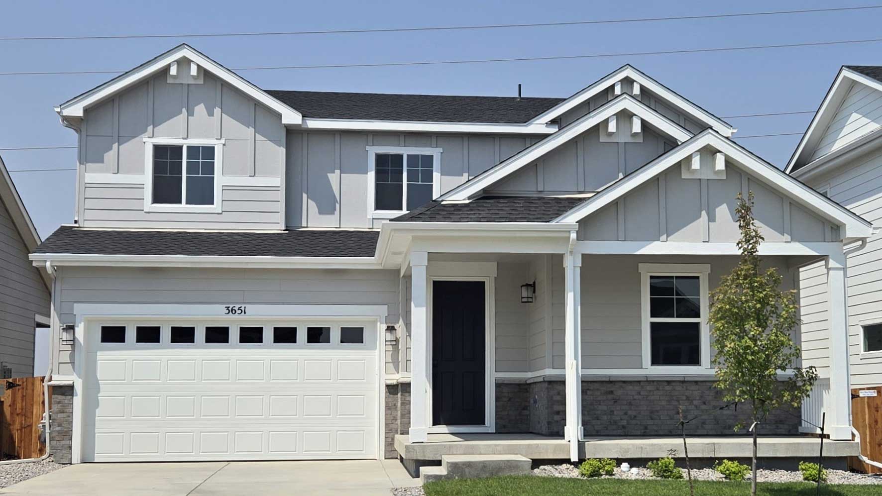 A white house with a garage.