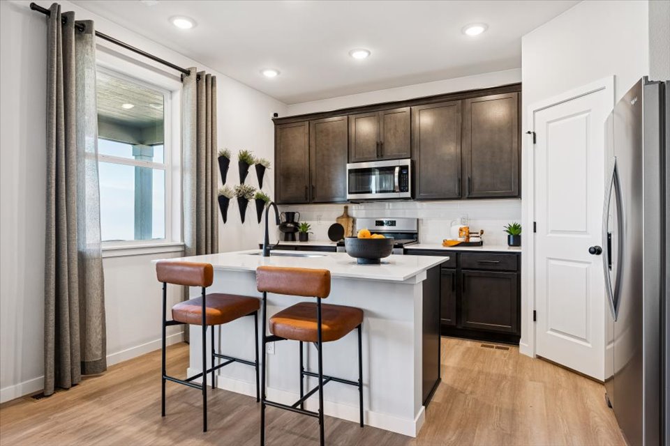 A kitchen with a table and chairs.