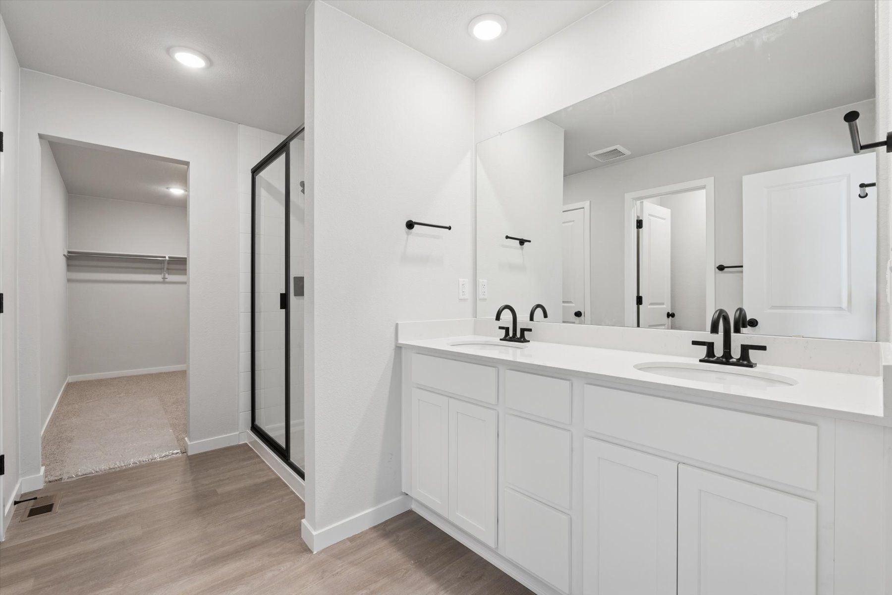A bathroom with white cabinets.