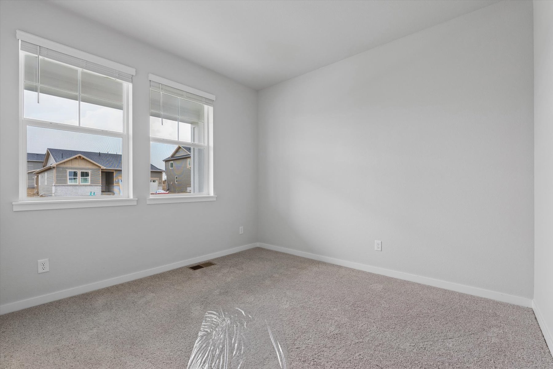 A room with a window and a carpet.