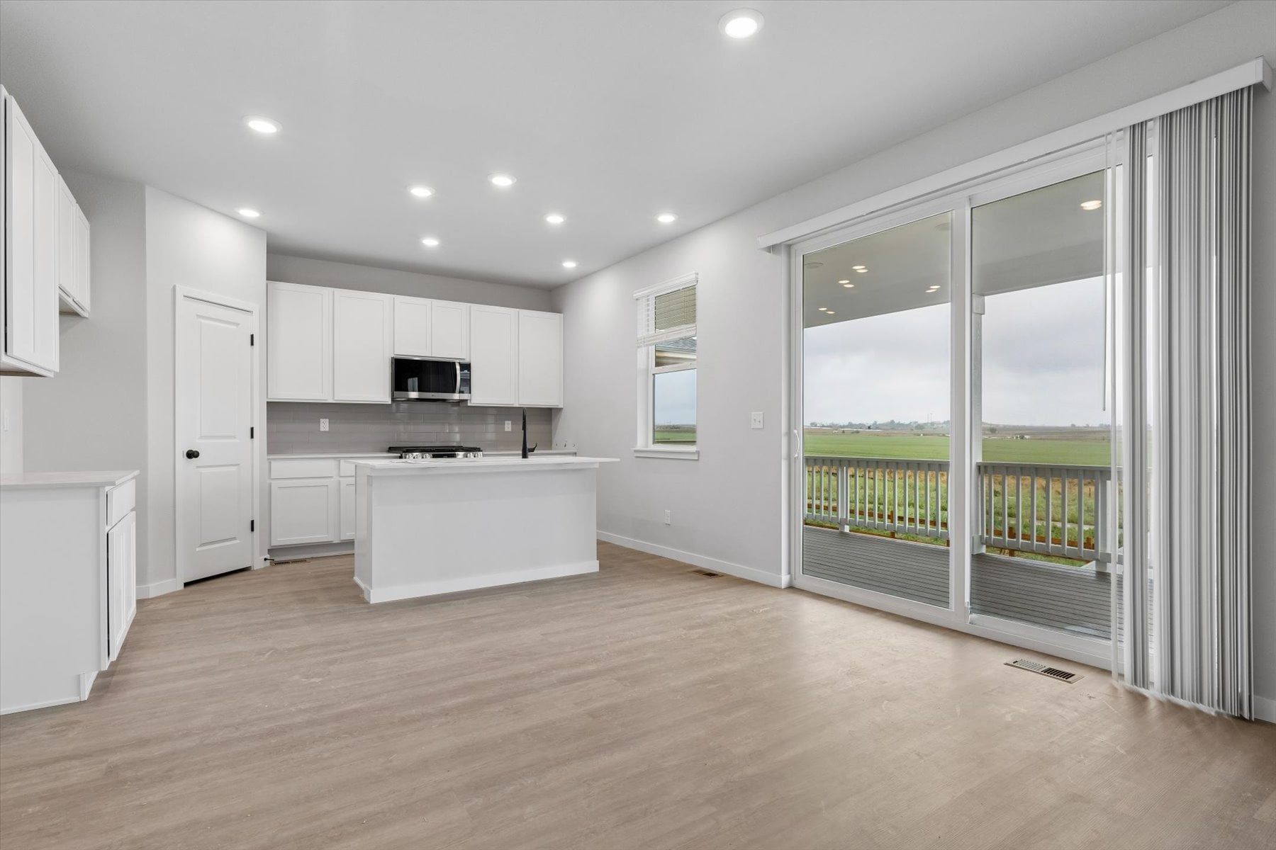 A large kitchen with white cabinets.