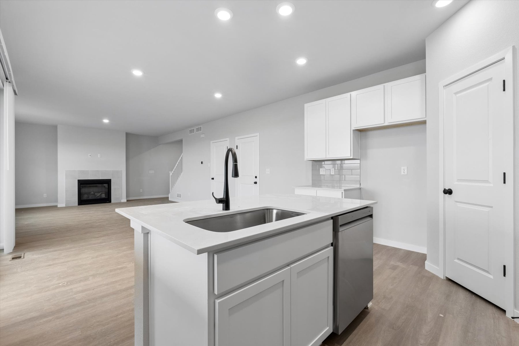 A kitchen with white cabinets.