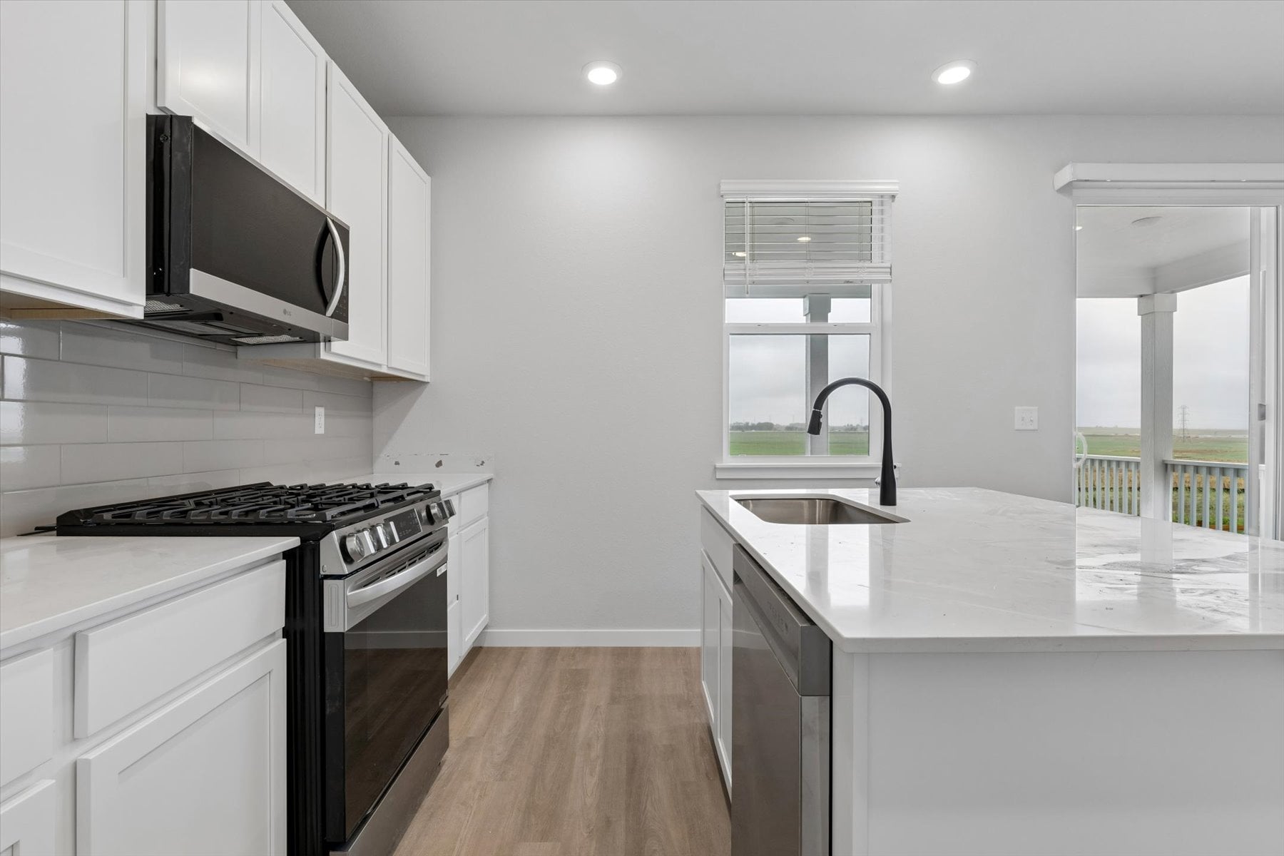 A kitchen with white cabinets.