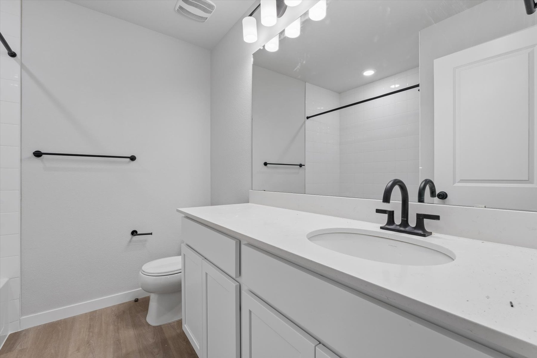 A bathroom with a sink and a toilet.